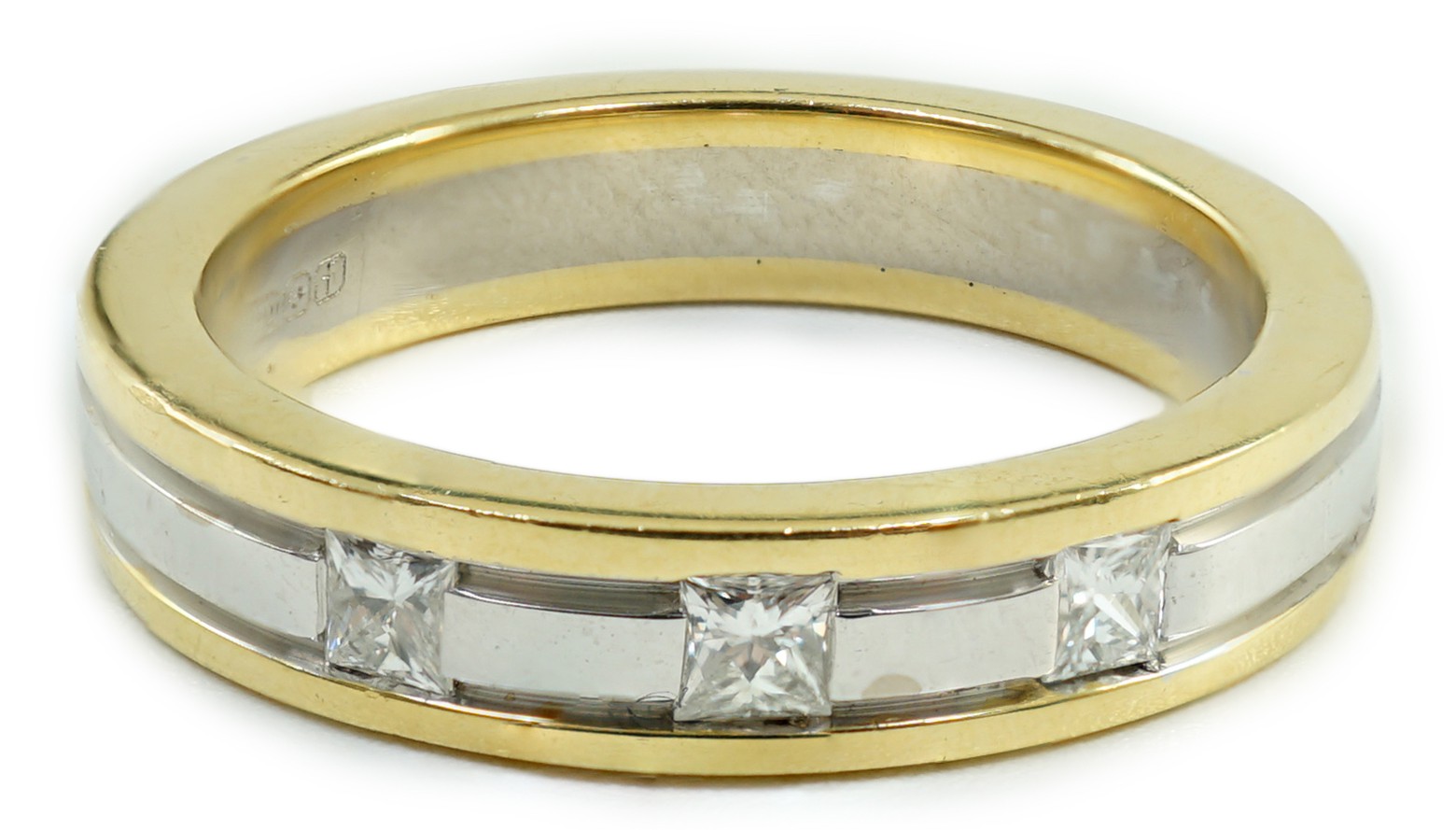 A modern Simbol two colour 18ct gold and gypsy set three stone diamond band, size M, gross weight 6.7 grams.                                                                                                                