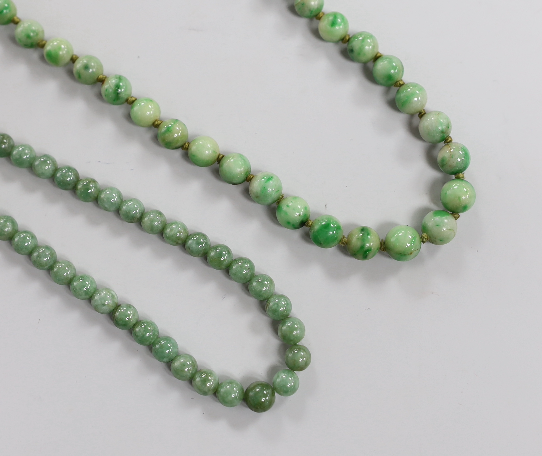 Two single strand graduated jade bead necklaces, 52cm & 84cm.                                                                                                                                                               