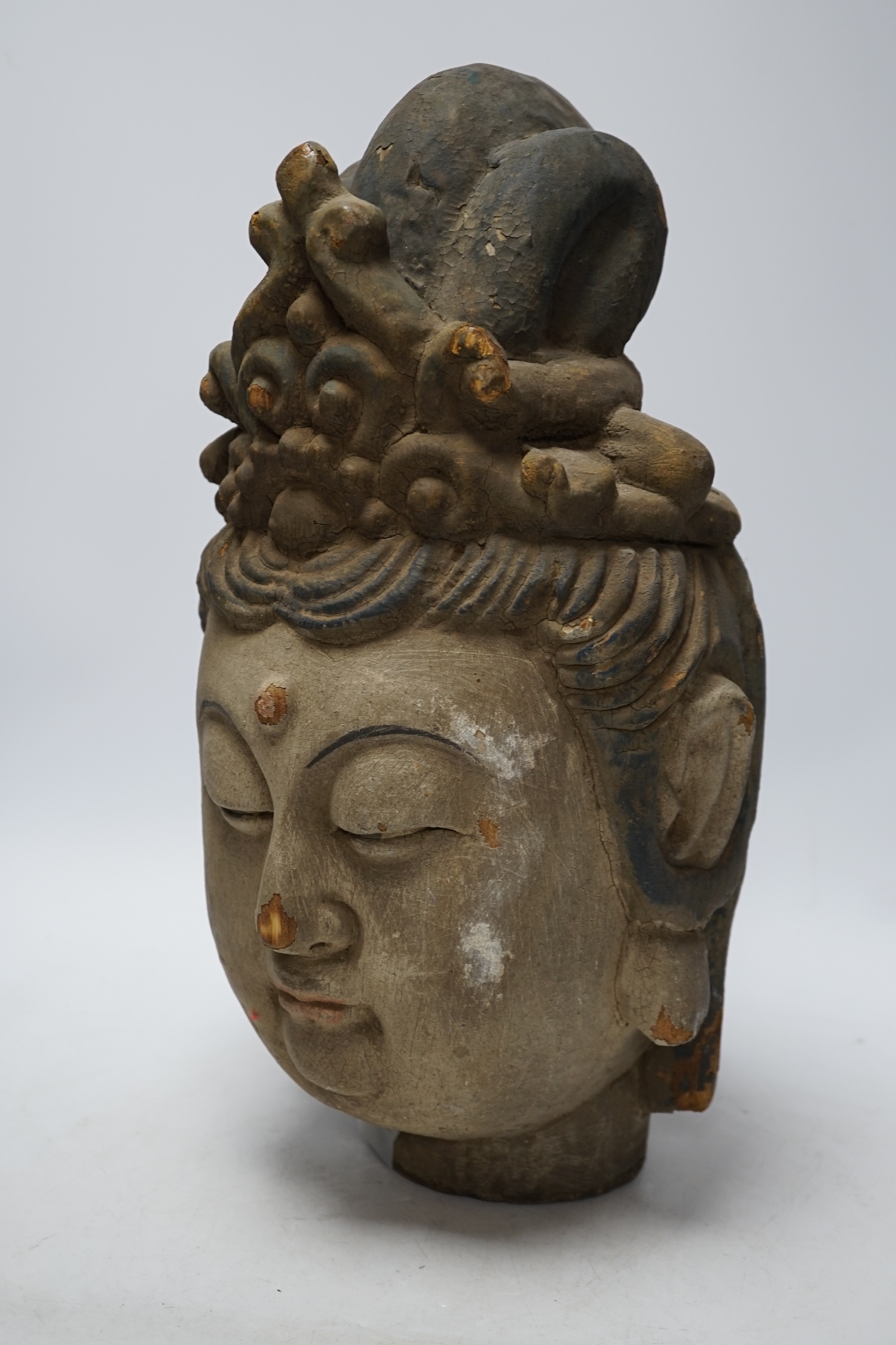 A Chinese painted wood head of Guanyin, Yuan style, 40cm                                                                                                                                                                    