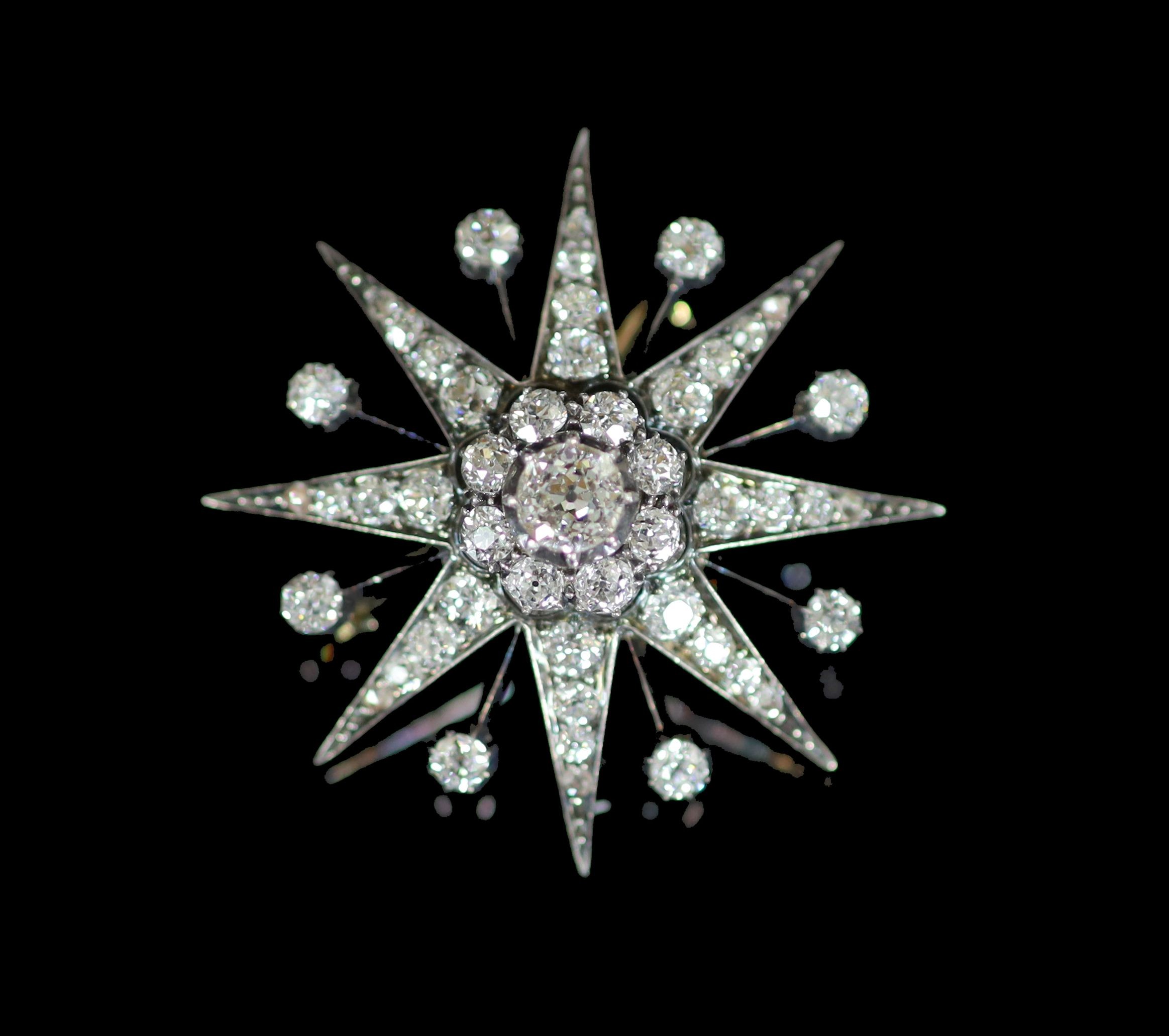 A Victorian gold, silver and diamond set starburst pendant brooch                                                                                                                                                           