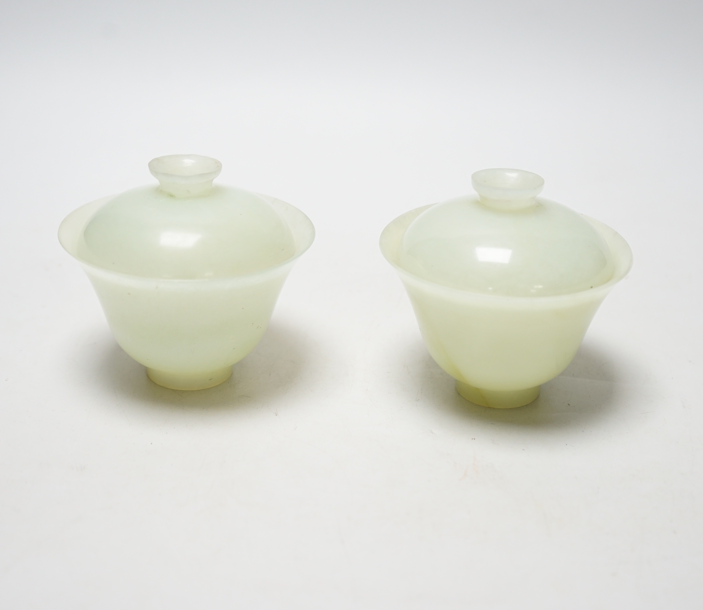 Pair of Chinese pale celadon jade footed bowls and covers, 9cm high                                                                                                                                                         