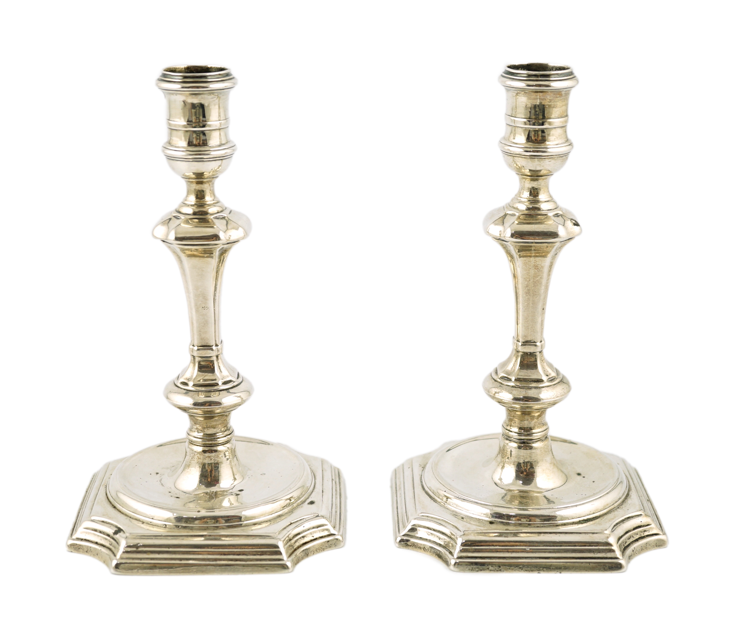 A pair of early George II cast silver table candlesticks, by John Gould                                                                                                                                                     