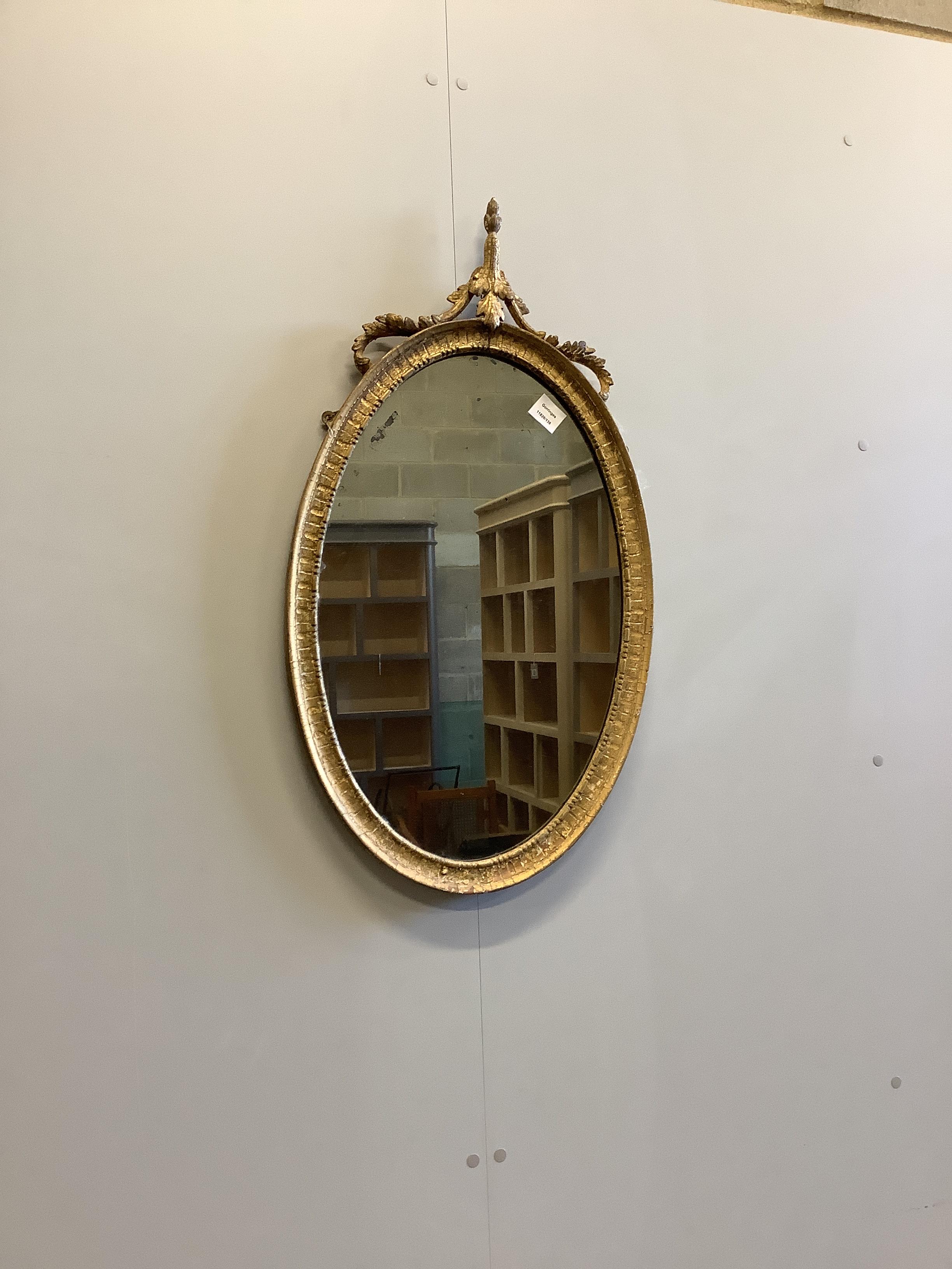 A Victorian oval giltwood and composition wall mirror of oval form, width 46cm, height 84cm                                                                                                                                 