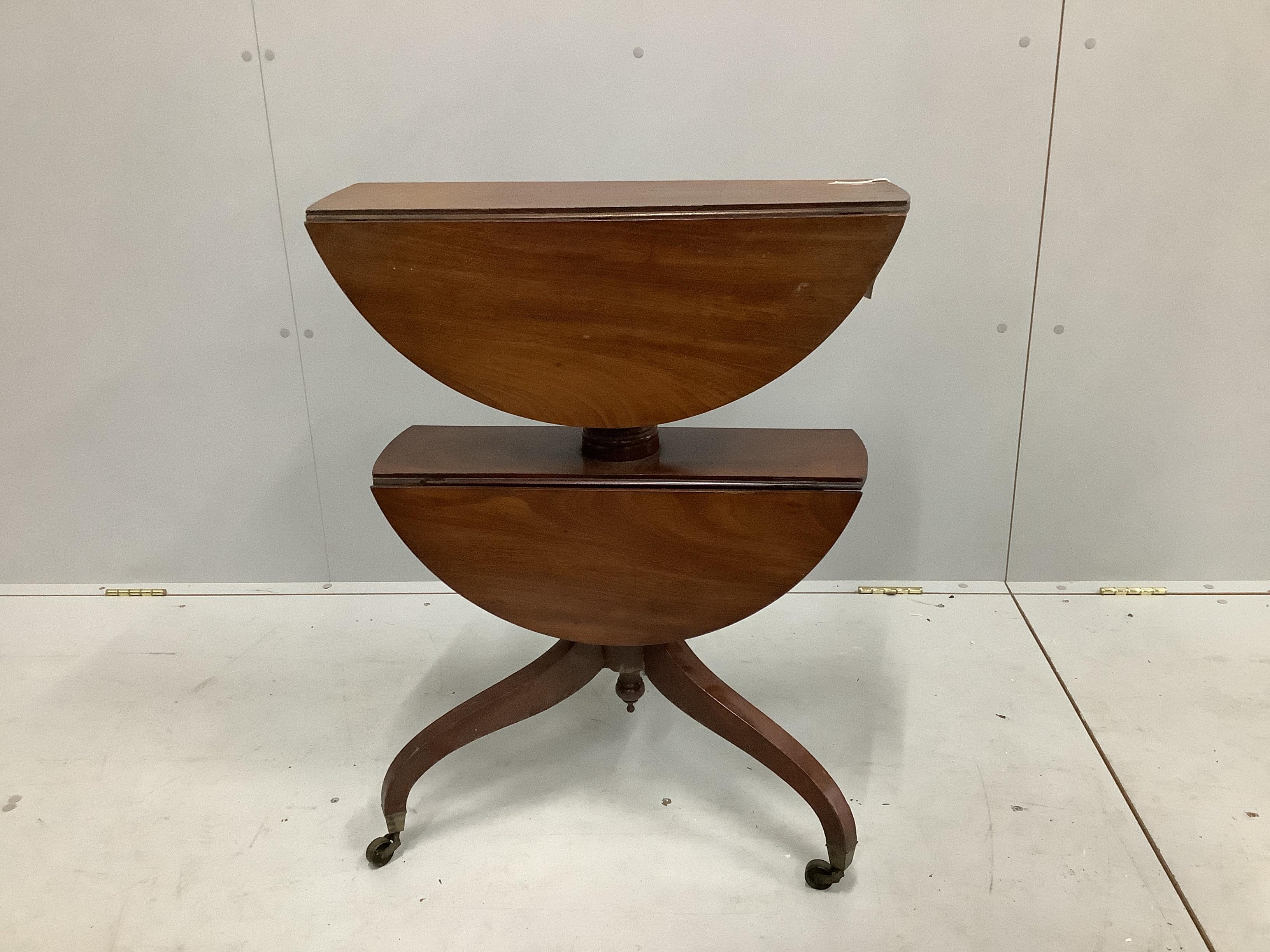A Regency circular mahogany two tier drop flap occasional table, diameter 63cm, height 76cm                                                                                                                                 