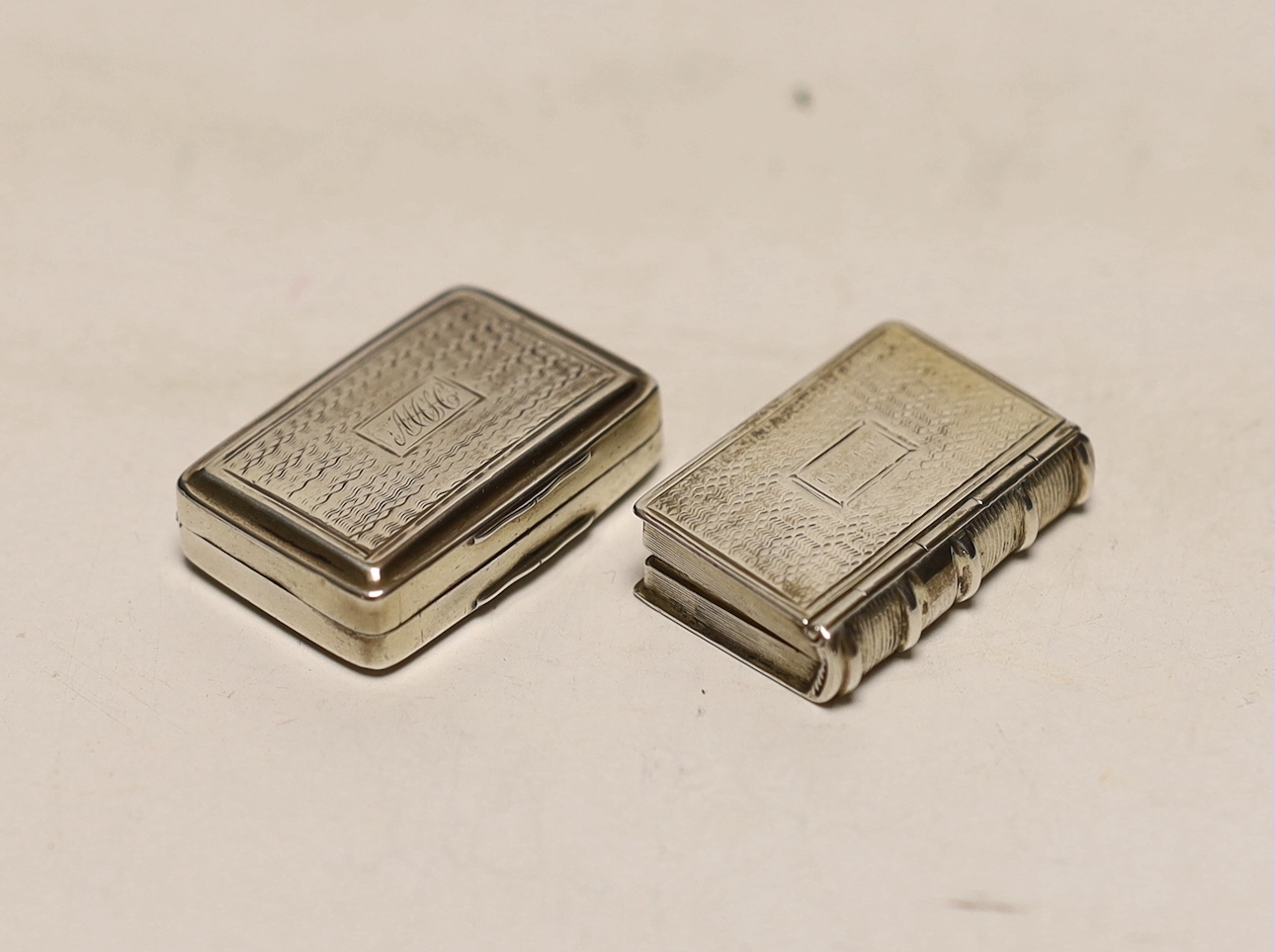 A George IV silver vinaigrette, modelled as a book, Taylor & Perry, Birmingham, circa 1825, 33mm and one other George III silver vinaigrette, Simpson & Son, Birmingham, 1819.                                              