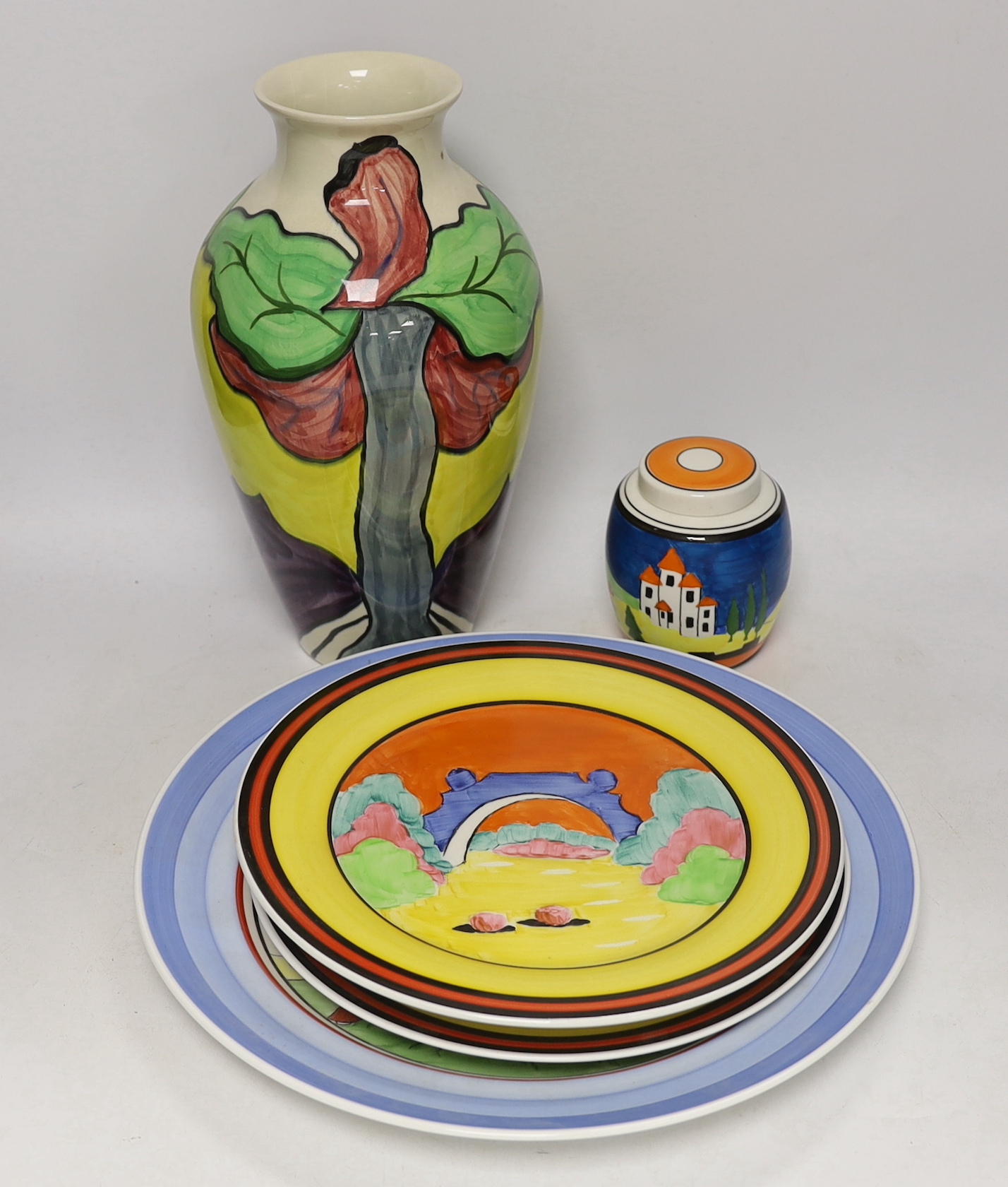 Four Clarice Cliff style plates, a similar vase and a jar and cover, tallest 31cm                                                                                                                                           