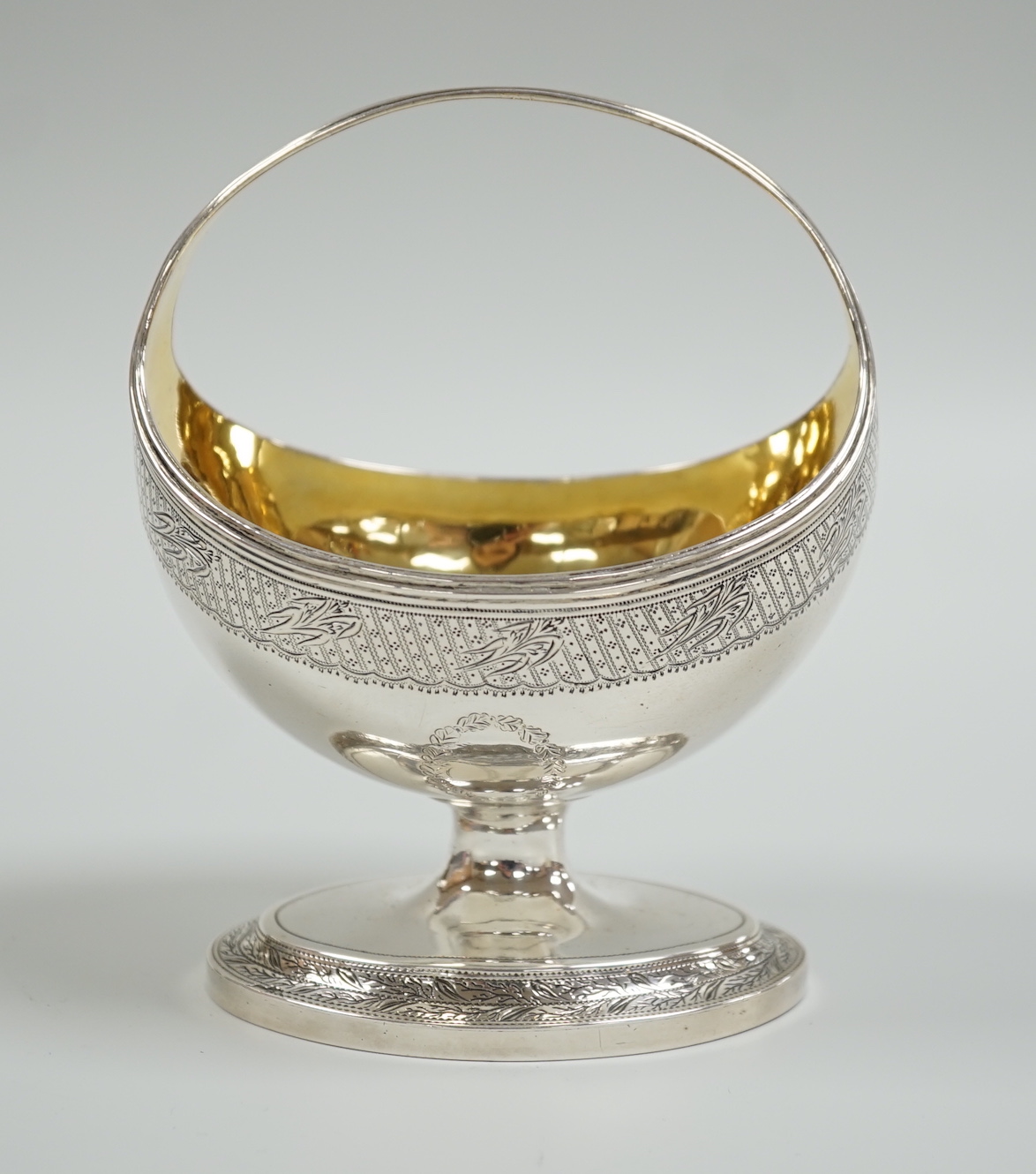 A George III engraved silver boat shaped sugar basket, with fixed handle, William Fountain, London, 1796, height 13cm, 7.2oz.                                                                                               