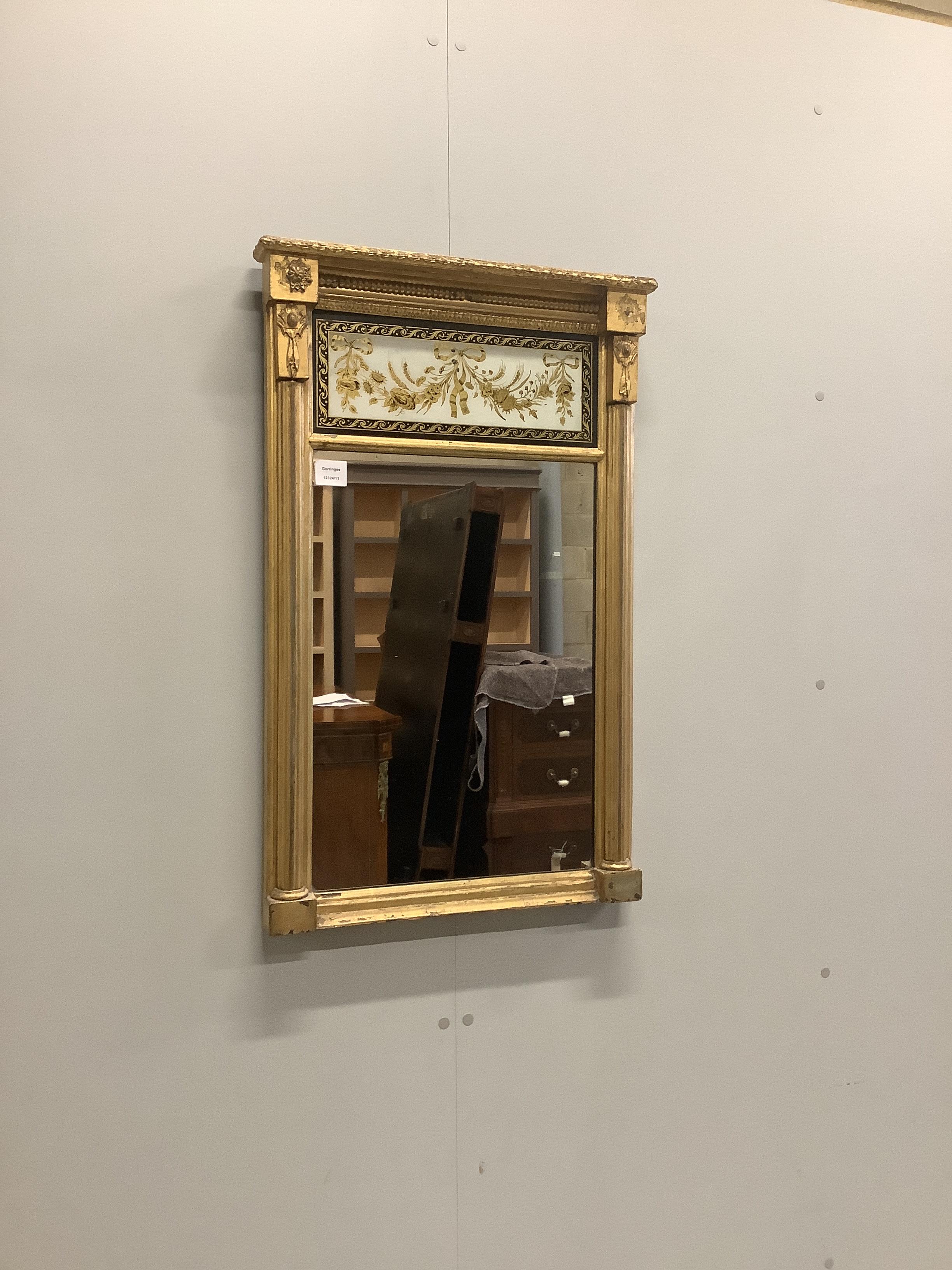 A Regency giltwood and composition pier glass with eglomisé tablet, width 53cm, height 84cm                                                                                                                                 