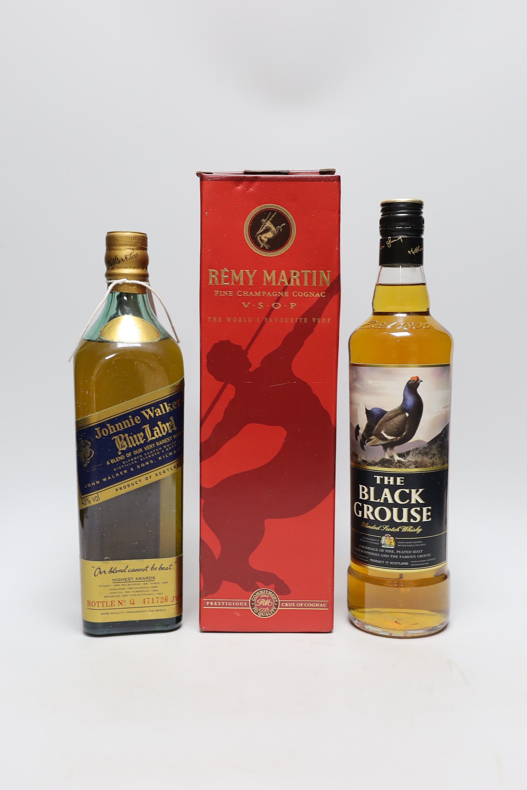A cased 70cl bottle of Remy Martin, a bottle of Johnnie Walker blue label and a bottle of The Black Grouse                                                                                                                  