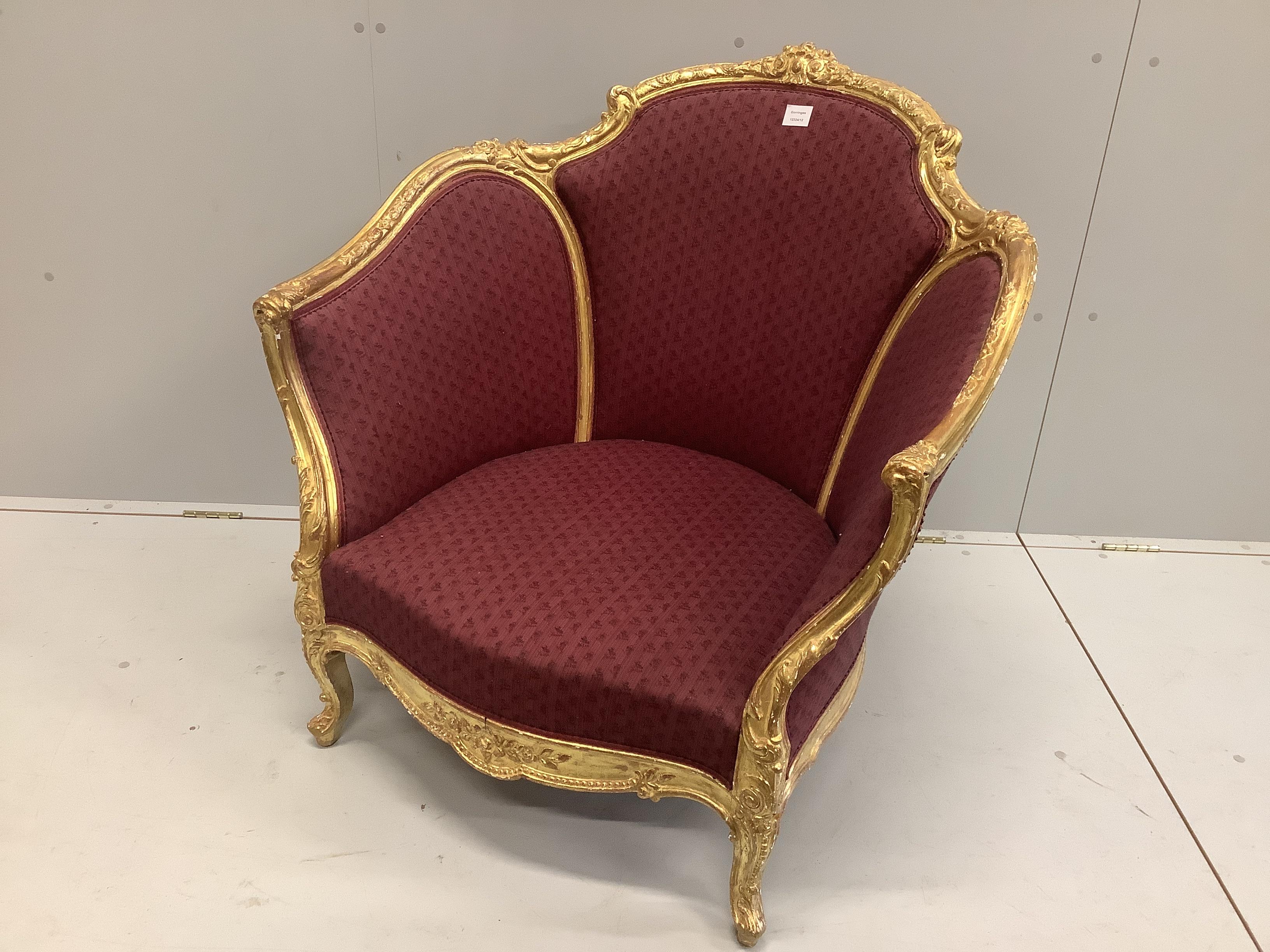 A Louis XVI style carved giltwood tub framed salon chair, width 90cm, depth 70cm, height 90cm                                                                                                                               