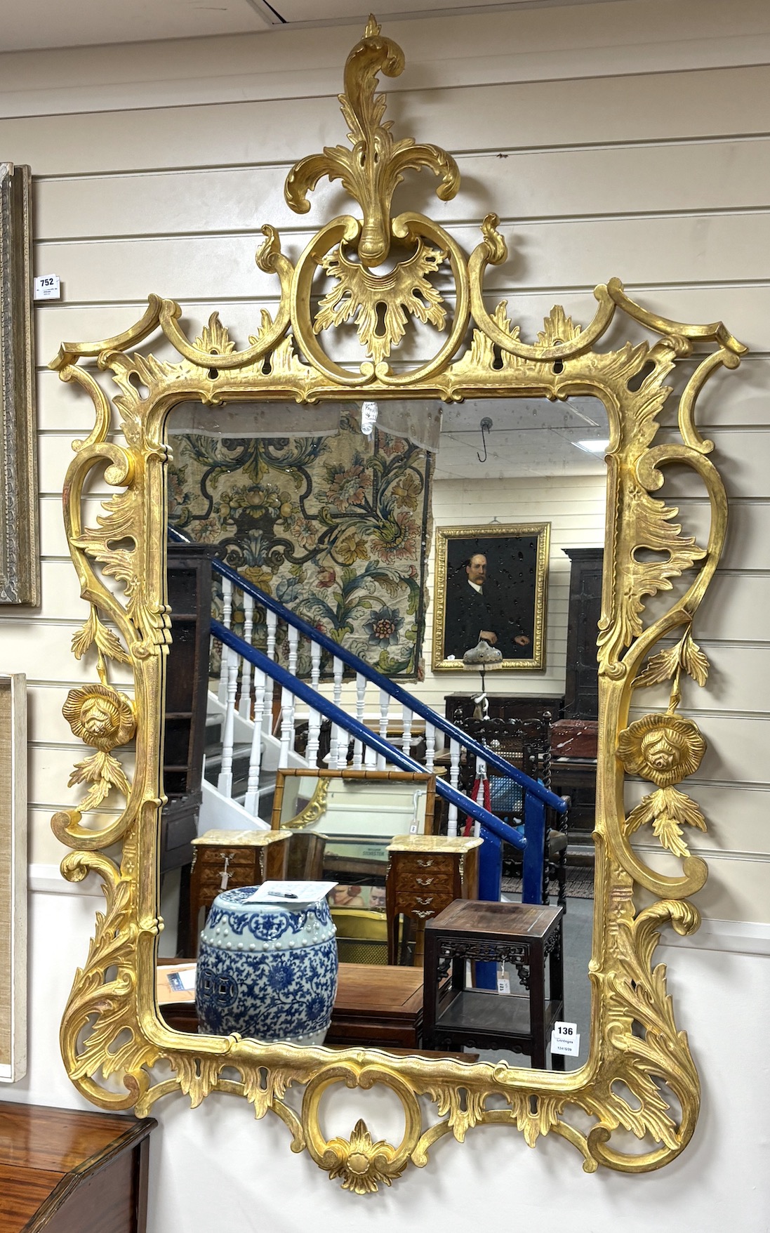 An 18th century style carved giltwood wall mirror, width 106cm, height 172cm                                                                                                                                                