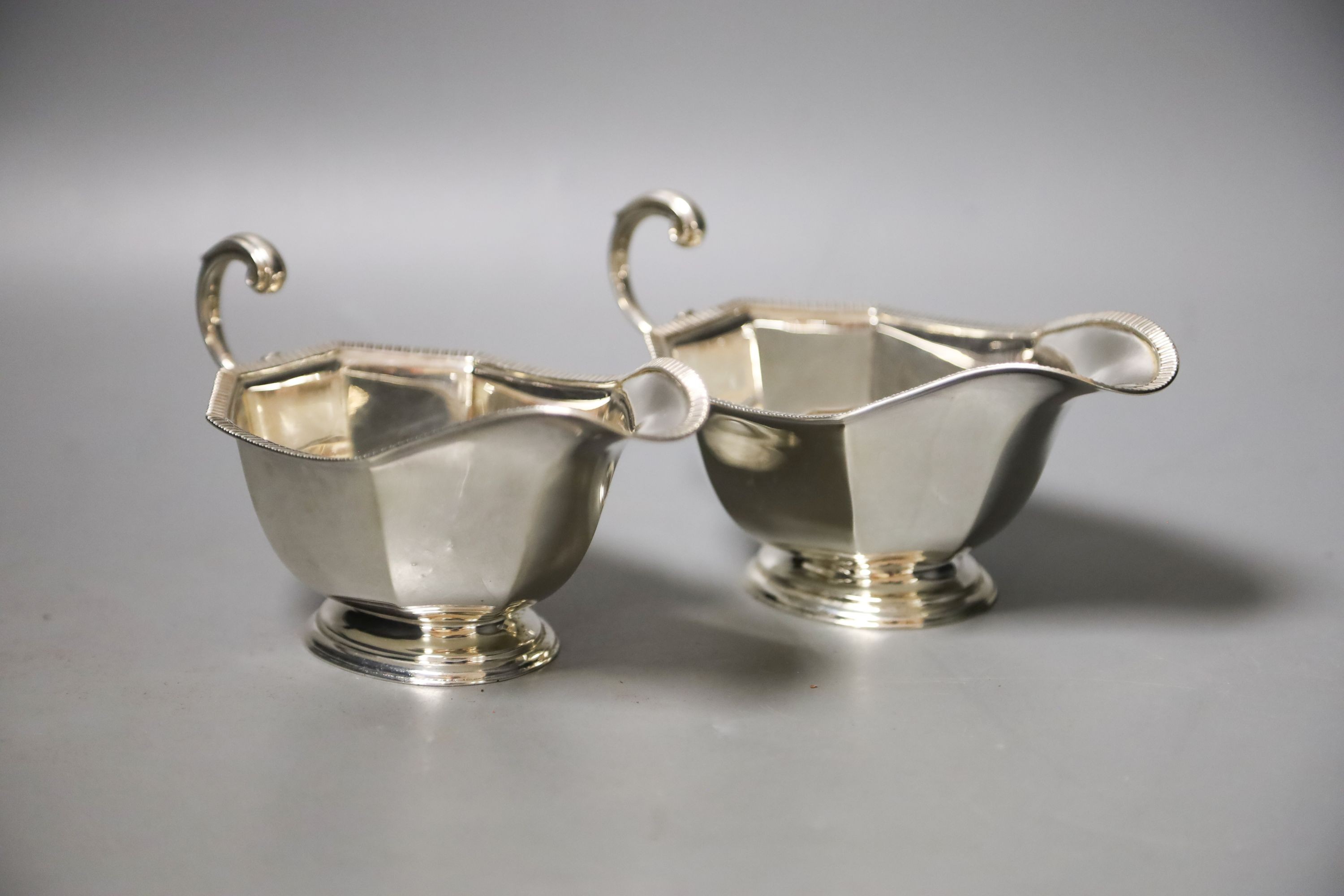 A pair of 1930's silver sauceboats, with flying scroll handles, 16.2cm, 8oz.                                                                                                                                                