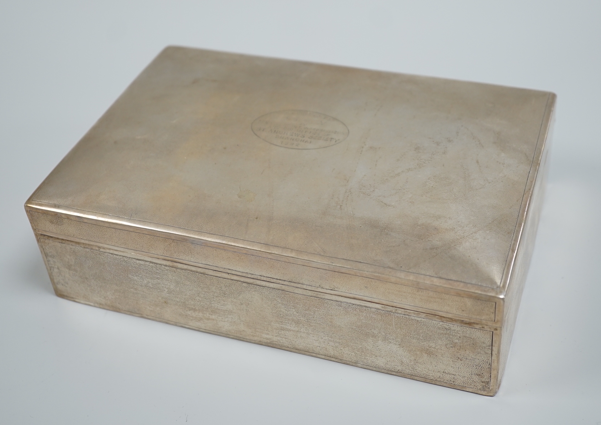 An early 20th century Chinese Export planished white metal mounted rectangular cigarette box, by Zee Wo, with engraved inscription, 22.8cm.                                                                                 