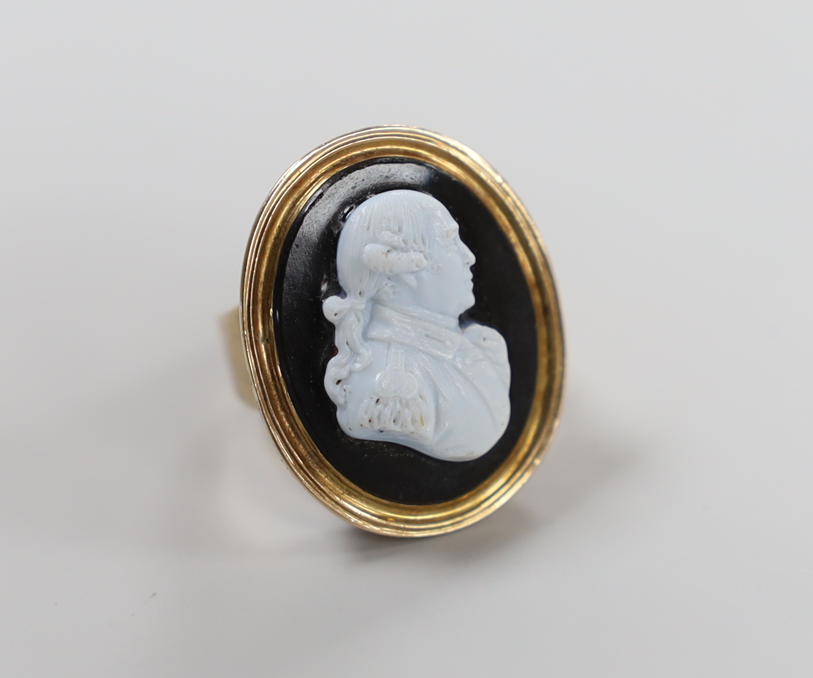 A 19th century and sardonyx cameo set oval ring, carved with the bust of a gentleman to sinister, size F/G, gross weight 8.9 grams.                                                                                         