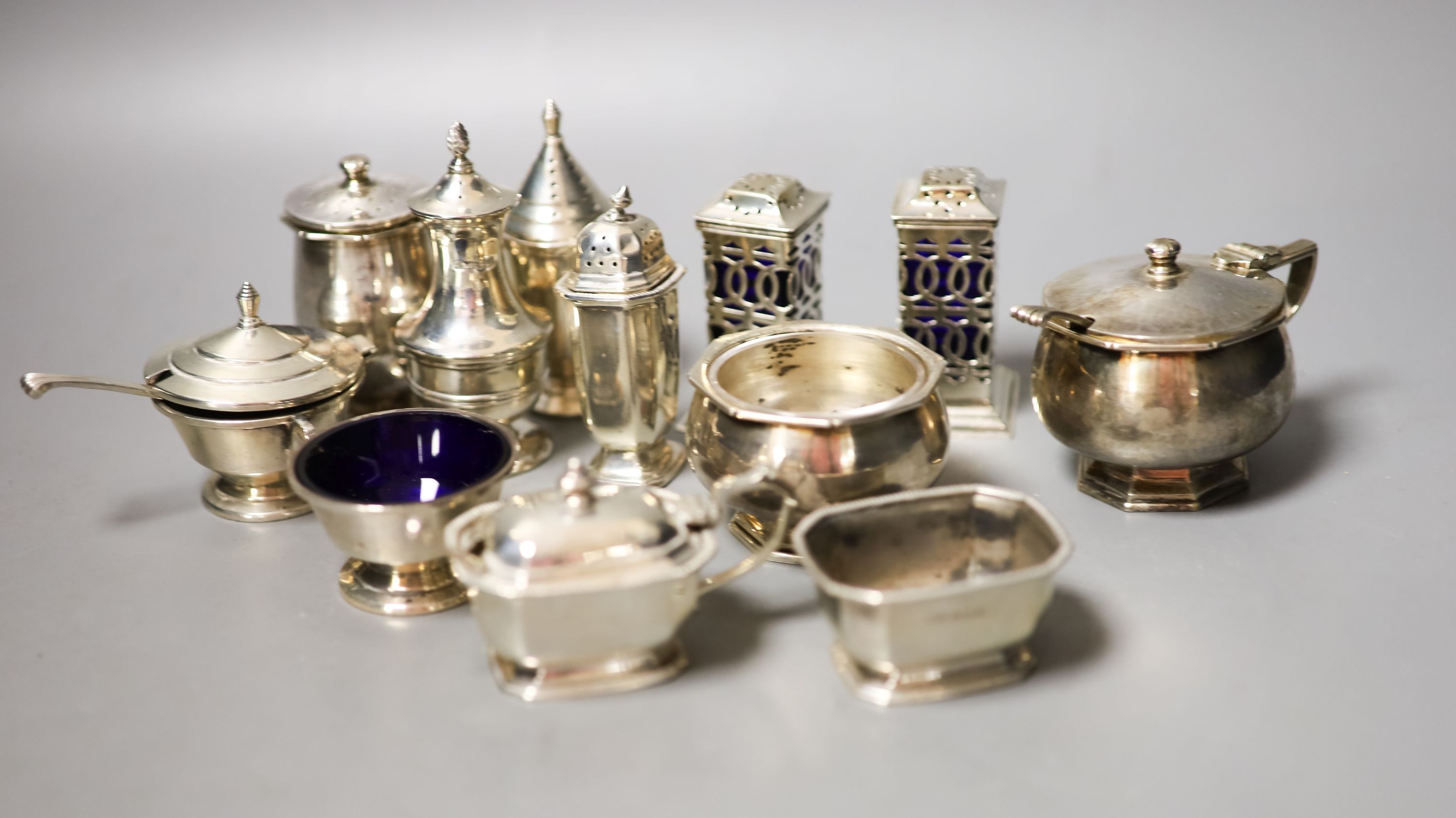 Twelve assorted 20th century silver condiments including an Art Deco three piece set, Birmingham, 1939.                                                                                                                     