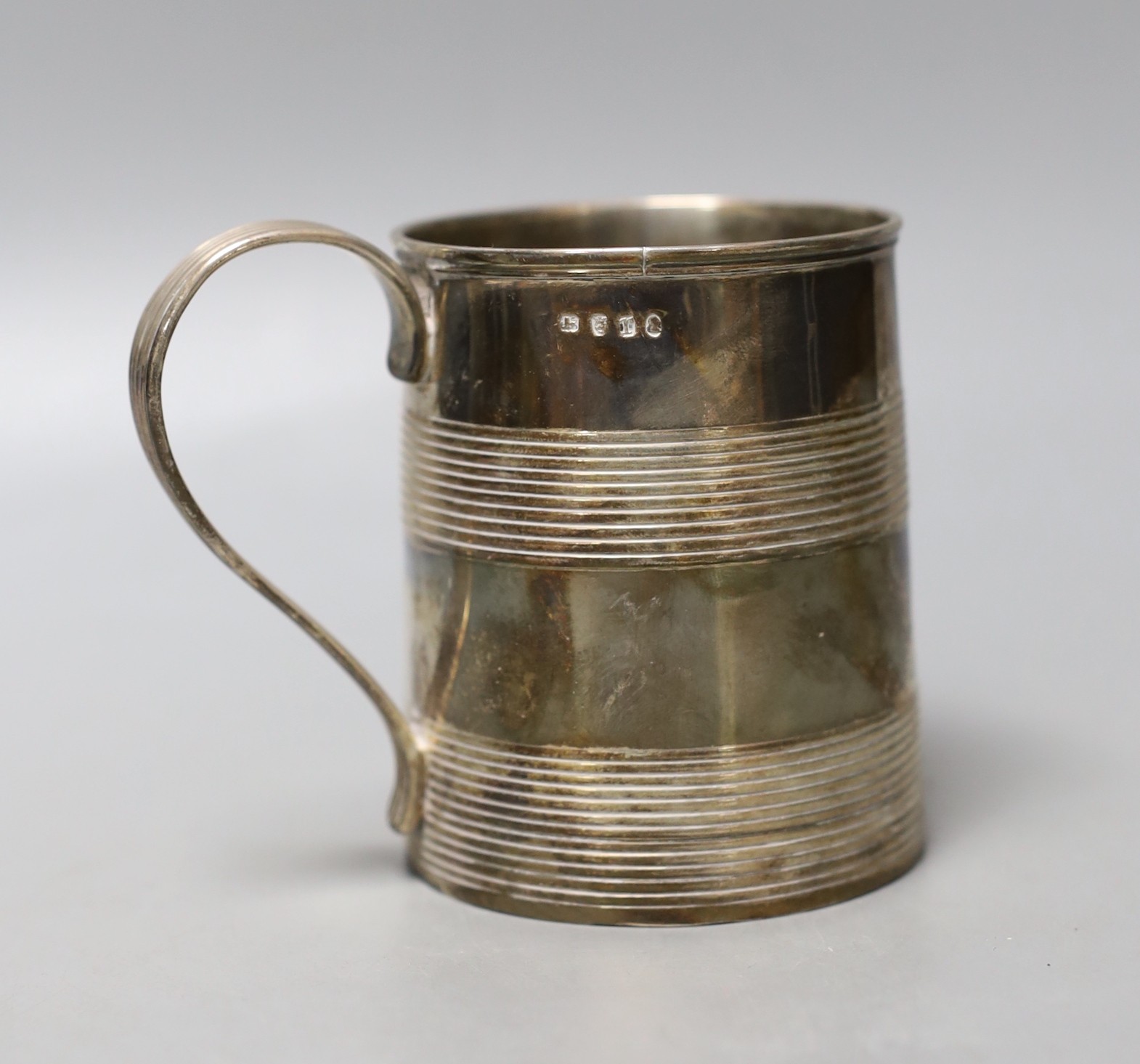 A George III silver mug, with two reeded bands and engraved inscription to the base, no maker's mark, London, 1801, 87mm, 203 grams.                                                                                        