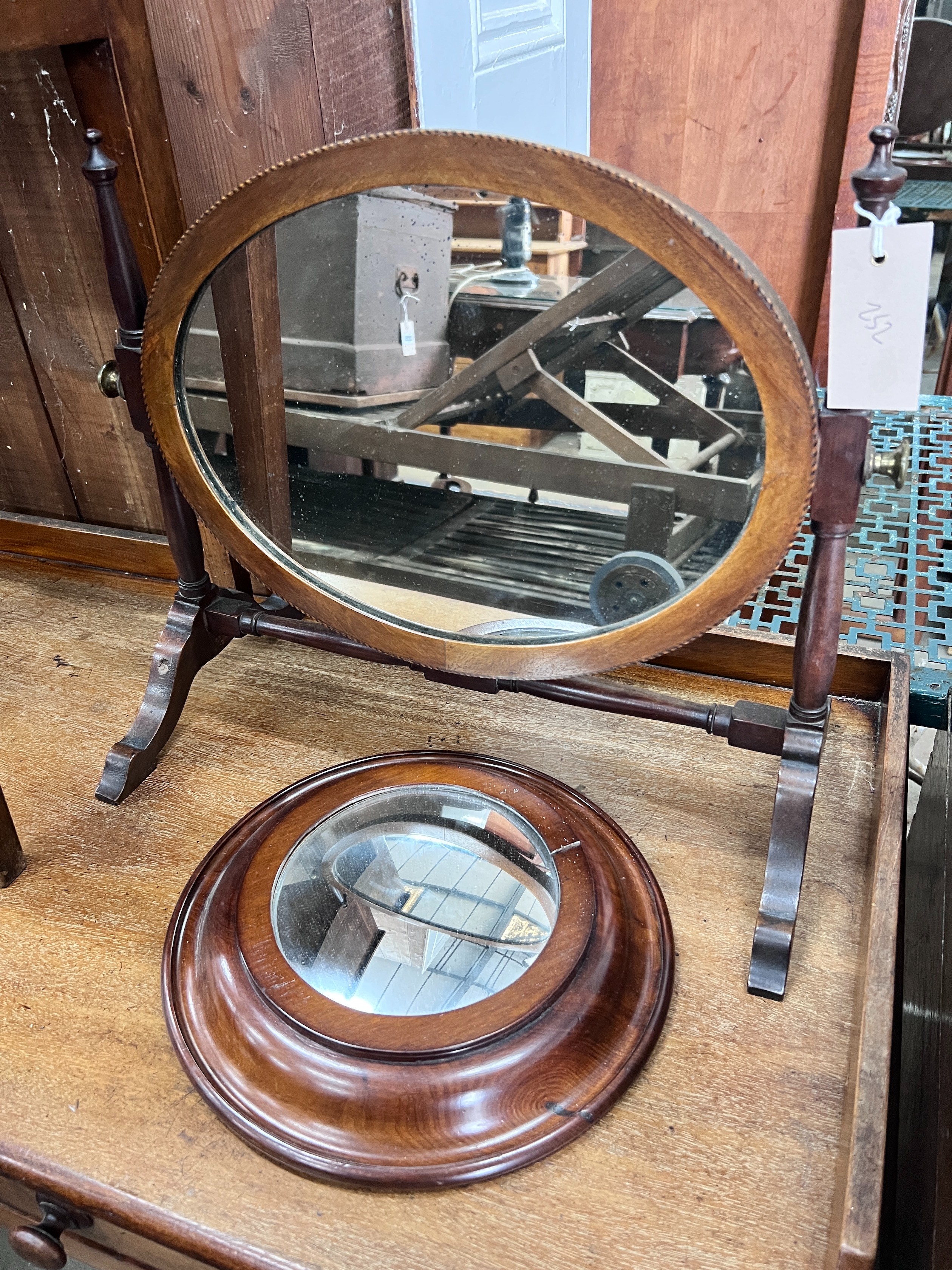 An Edwardian skeleton toilet mirror, 44cm, and a convex wall mirror, 26cm *Please note the sale commences at 9am.                                                                                                           