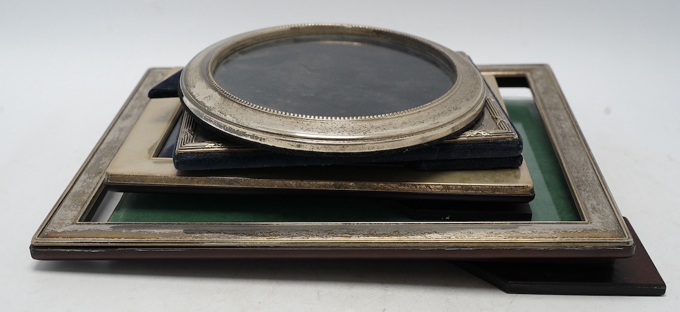Four assorted modern silver mounted photograph frames, largest 29.2cm. Condition - fair                                                                                                                                     