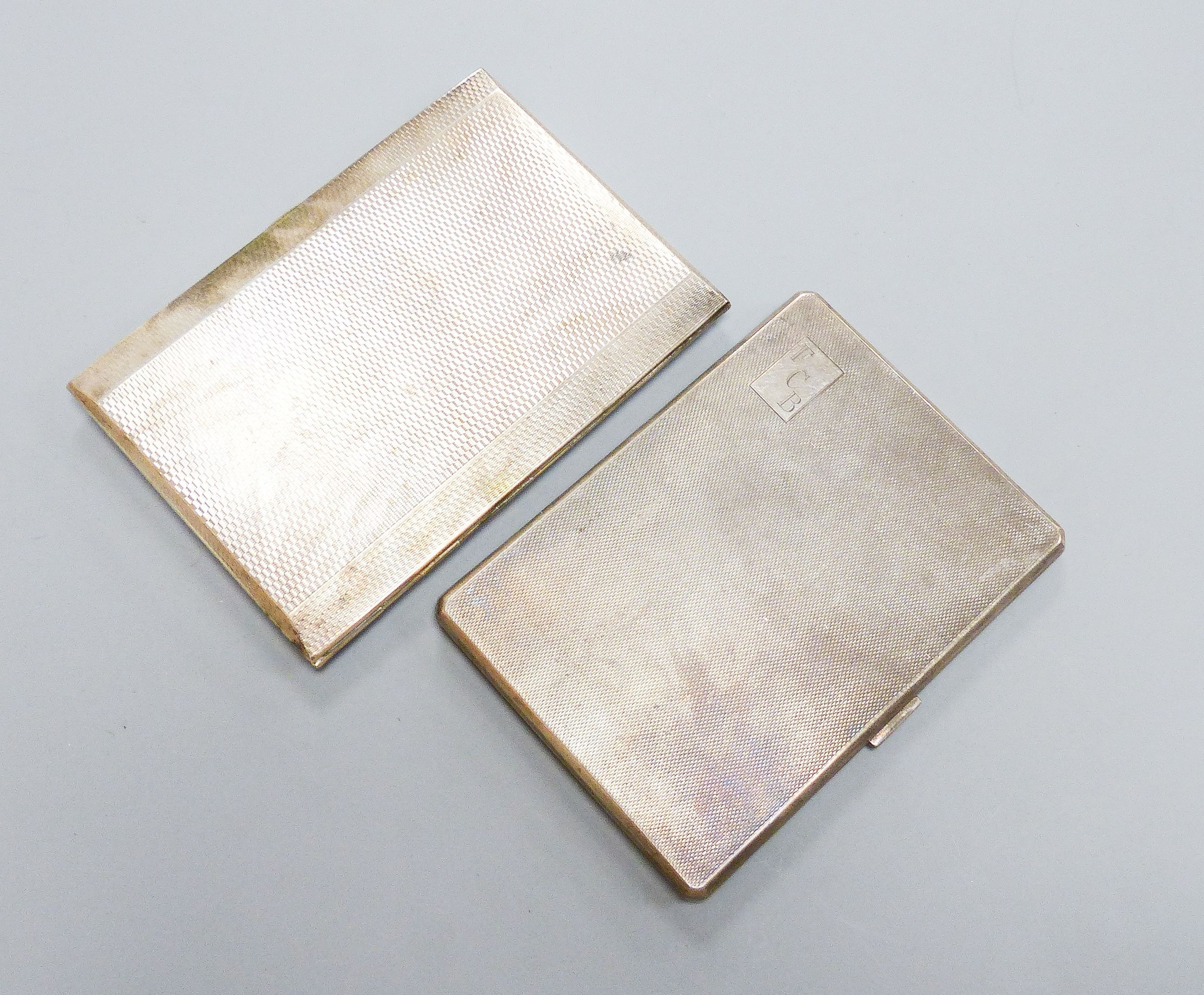 Two George V engine turned silver cigarette cases, largest 12.4cm, gross 12.5oz.                                                                                                                                            