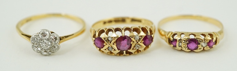 Two early 20th century yellow metal, ruby and diamond cluster set half hoop rings, one hallmarked 18ct gold and an 18ct and diamond cluster set ring, gross weight 7.1 grams. Condition - poor to fair                      