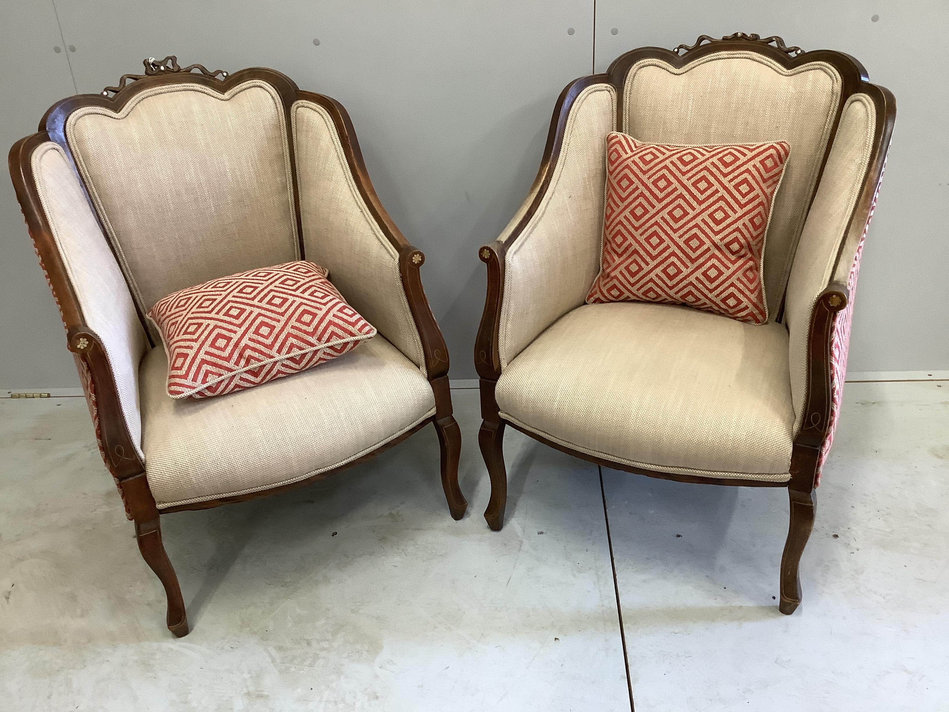A pair of Edwardian inlaid mahogany upholstered armchairs, width 65cm, depth 66cm, height 90cm                                                                                                                              
