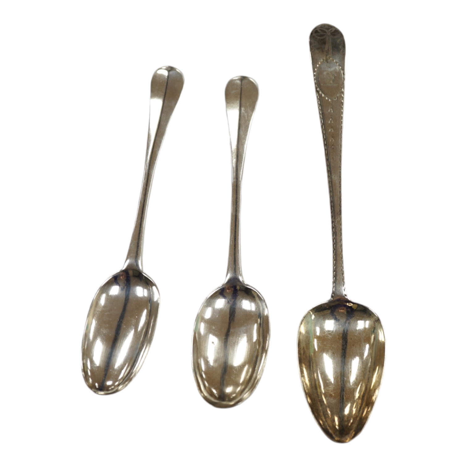 A pair of early 18th century English? provincial silver Hanovarian rat tail table spoons, three stamps WS,WS & SB? only, 19.4cm, together with a George III Irish bright cut engraved silver table spoon, J. Brady, Dublin, 