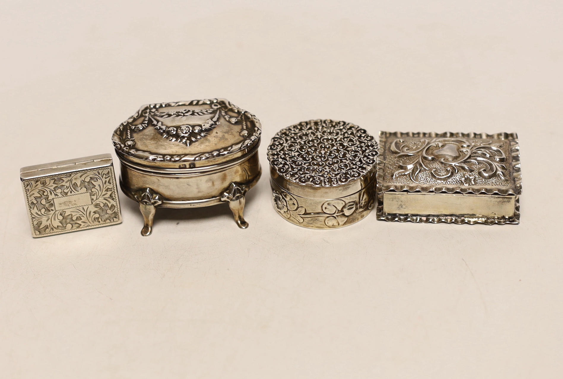 An Edwardian silver mounted trinket box, Henry Matthews, Birmingham, 1909, 51mm, a George V silver circular pot pourri? box, by William Comyns and two snuff or pill boxes.                                                 