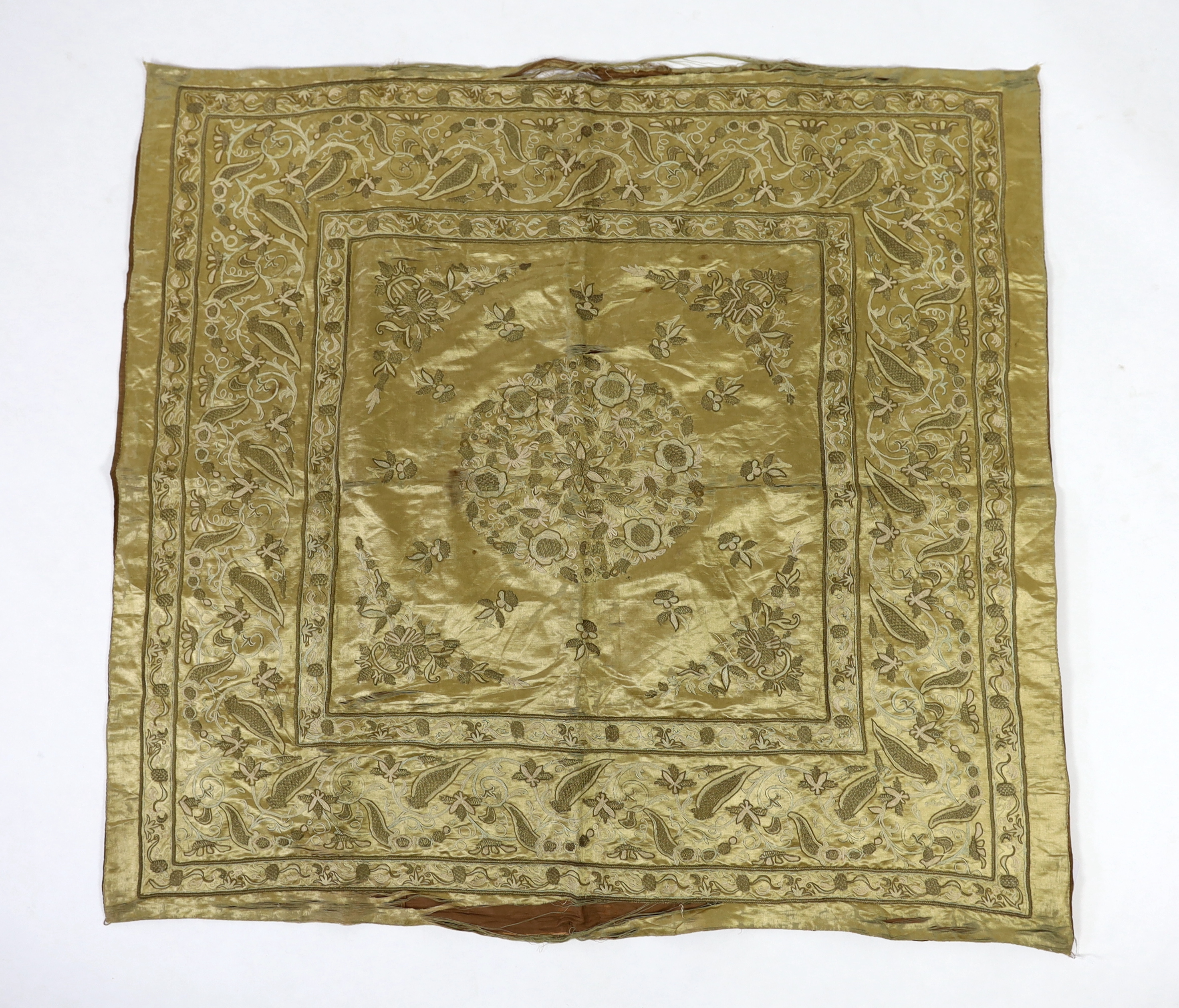 A late 19th century Turkish metallic thread and chain stitch silk satin cover, embroidered with a central cartouche of flowers and print, with rows of various borders with similar embroidery, 123 x 116cm                 