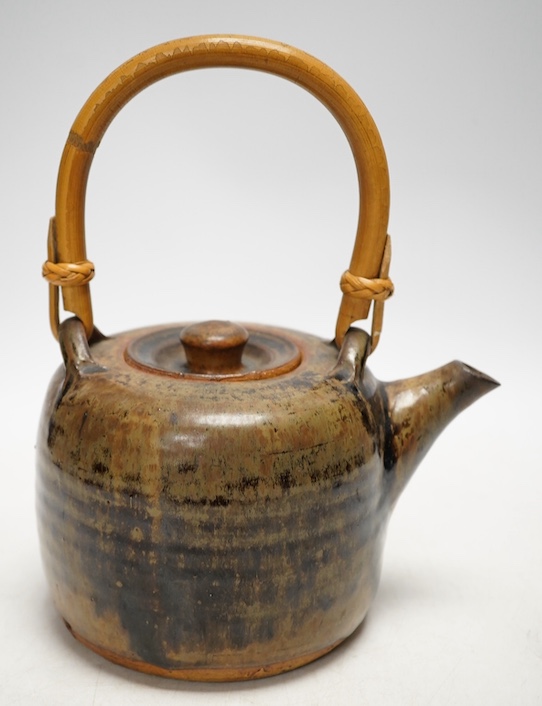 Pierre Culot (Belgian, 1938-2011), a studio pottery teapot with bamboo handle, stamped to the foot rim, 23cm high. Condition - fair to good, minor chipping                                                                 