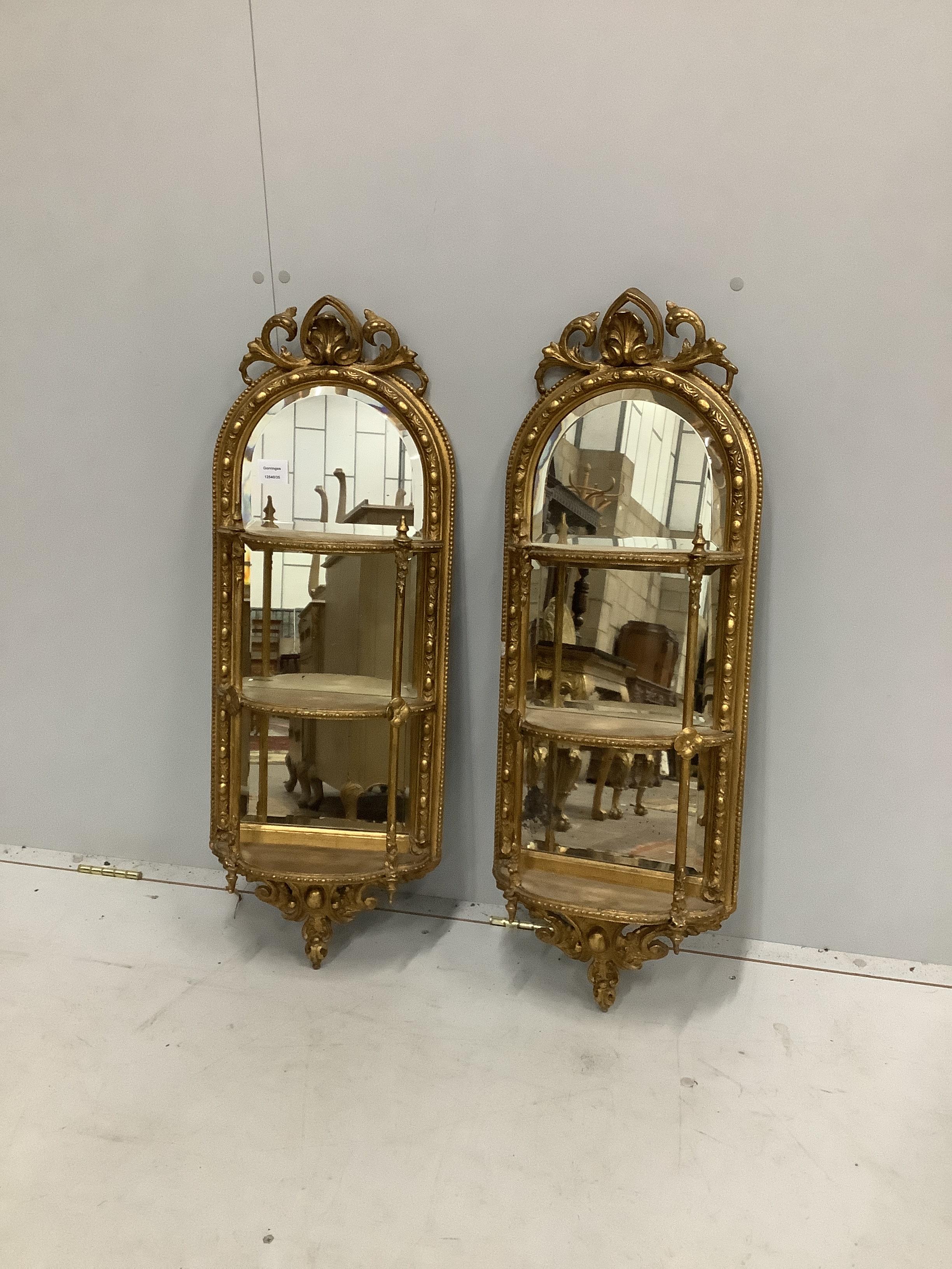 A pair of Victorian giltwood and composition mirrored three tier wall brackets, width 32cm, height 85cm                                                                                                                     