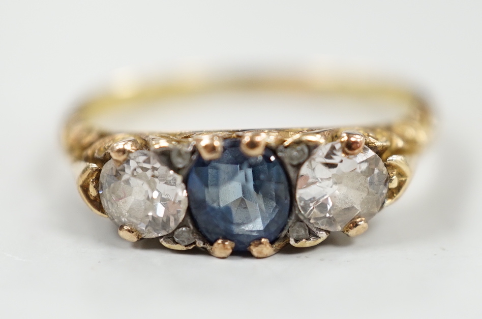 An 18ct, single stone sapphire and two stone diamond set half hoop ring, size P/Q, gross weight 3.2 grams.                                                                                                                  