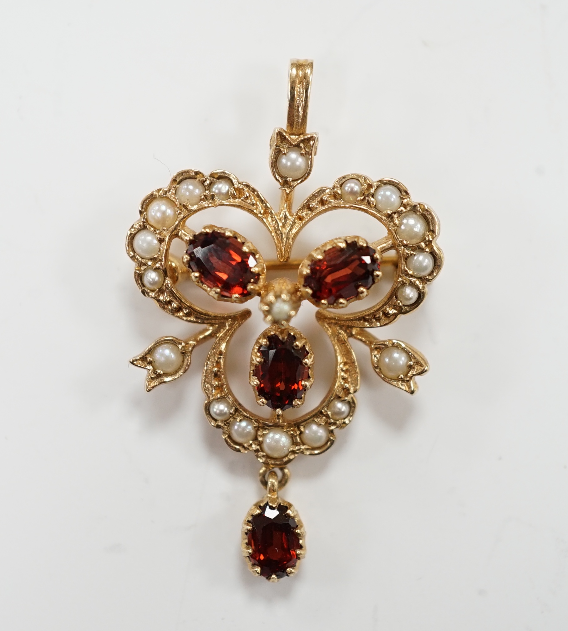 A modern 9ct gold garnet and seed pearl cluster set drop pendant brooch, 39mm, gross weight 4.8 grams.                                                                                                                      