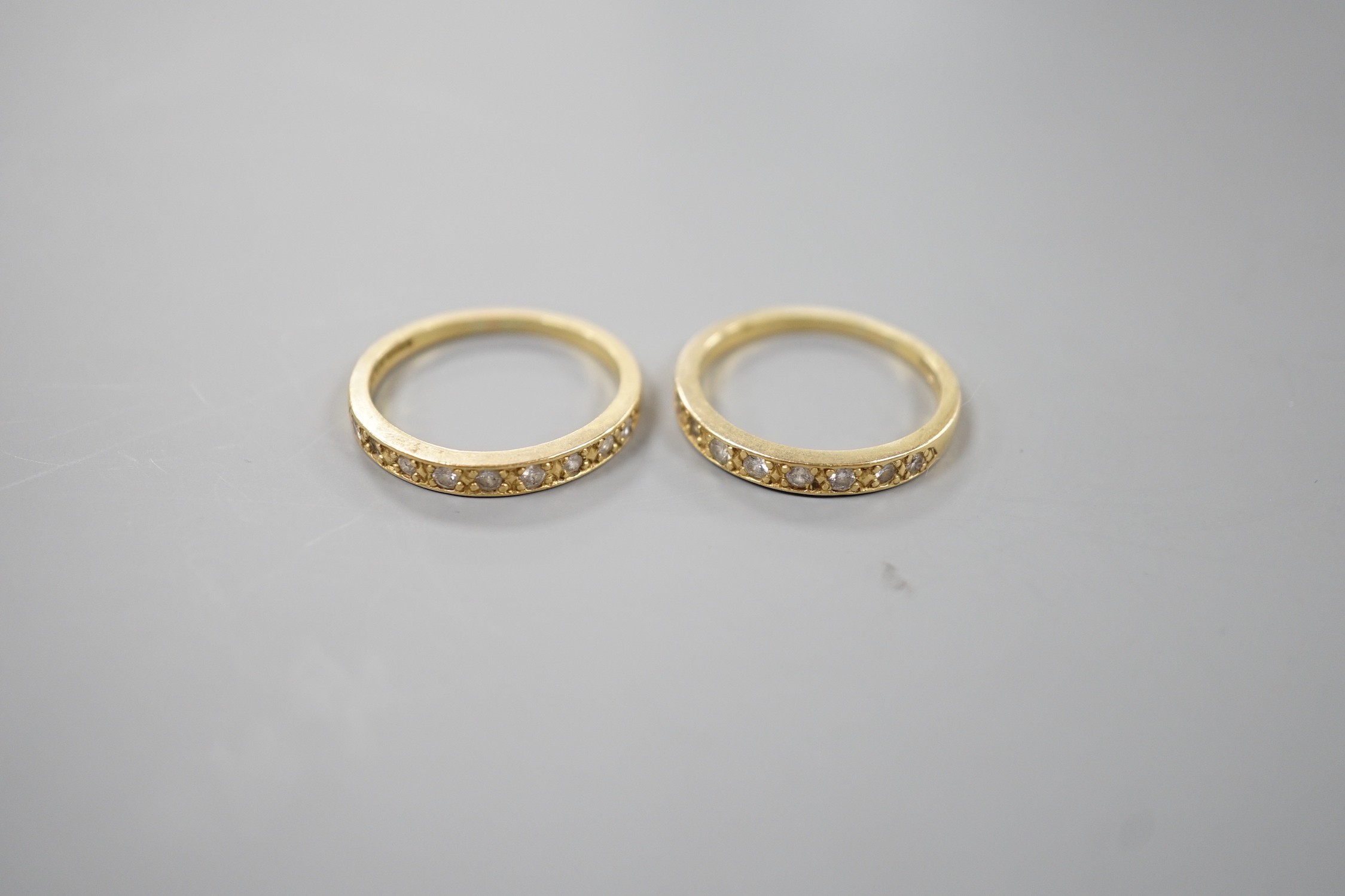 A modern pair of 18ct gold and diamond set half eternity rings, size P, gross weight 5.9 grams.                                                                                                                             