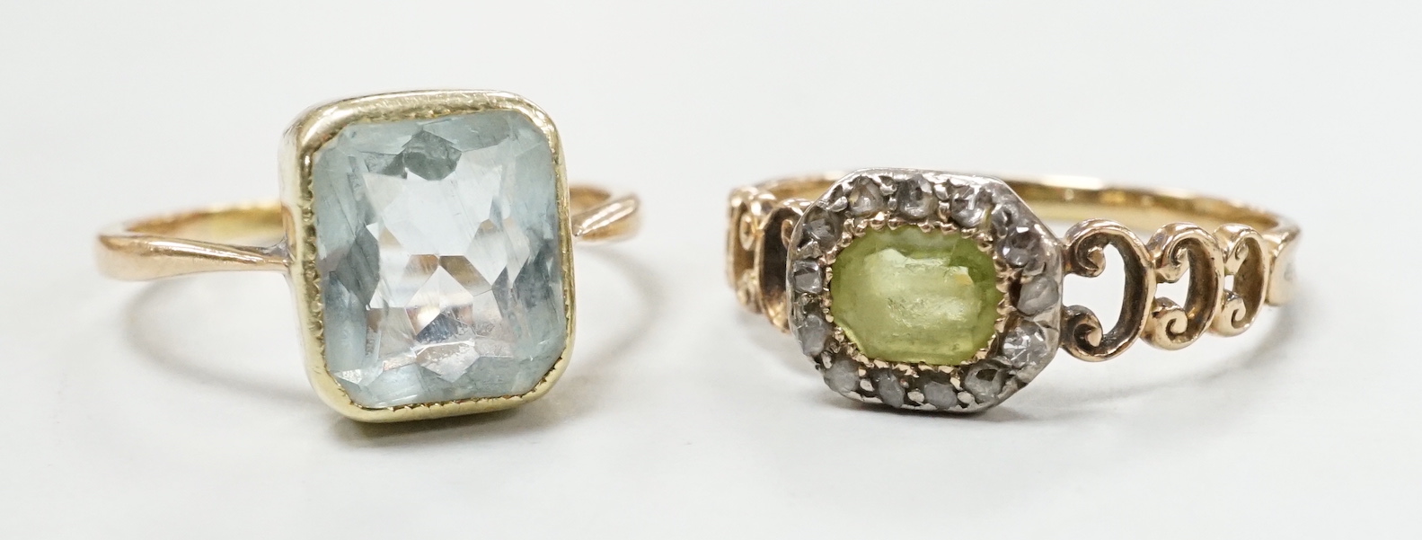 A late Victorian 15ct, peridot and diamond cluster set ring, size M and an Edwardian 15ct and aquamarine set ring, size K, gross weight 4.3 grams.                                                                          