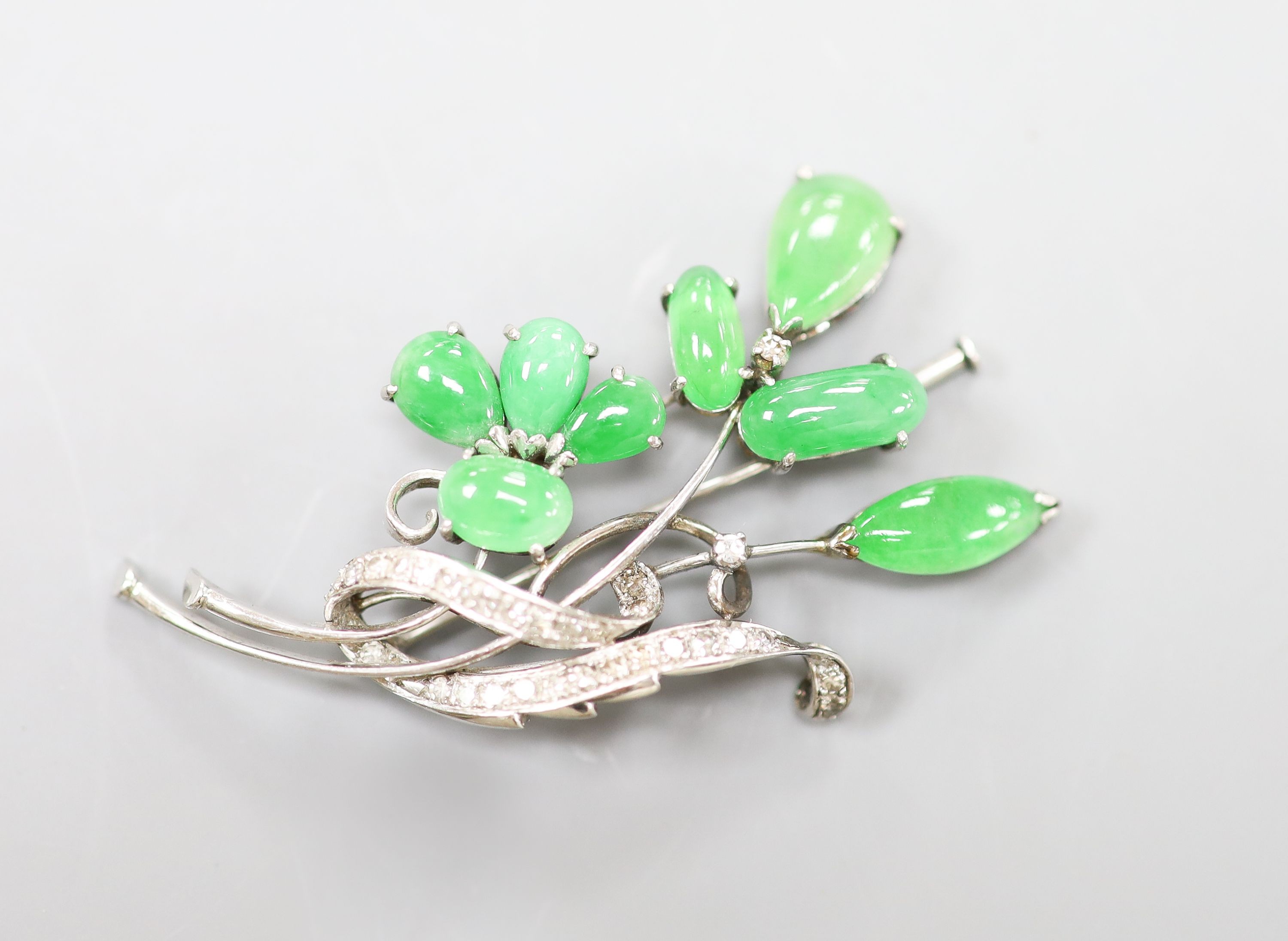 A white metal (stamped Plat), jade and diamond cluster set spray brooch, 50mm, gross weight 11.8 grams.                                                                                                                     