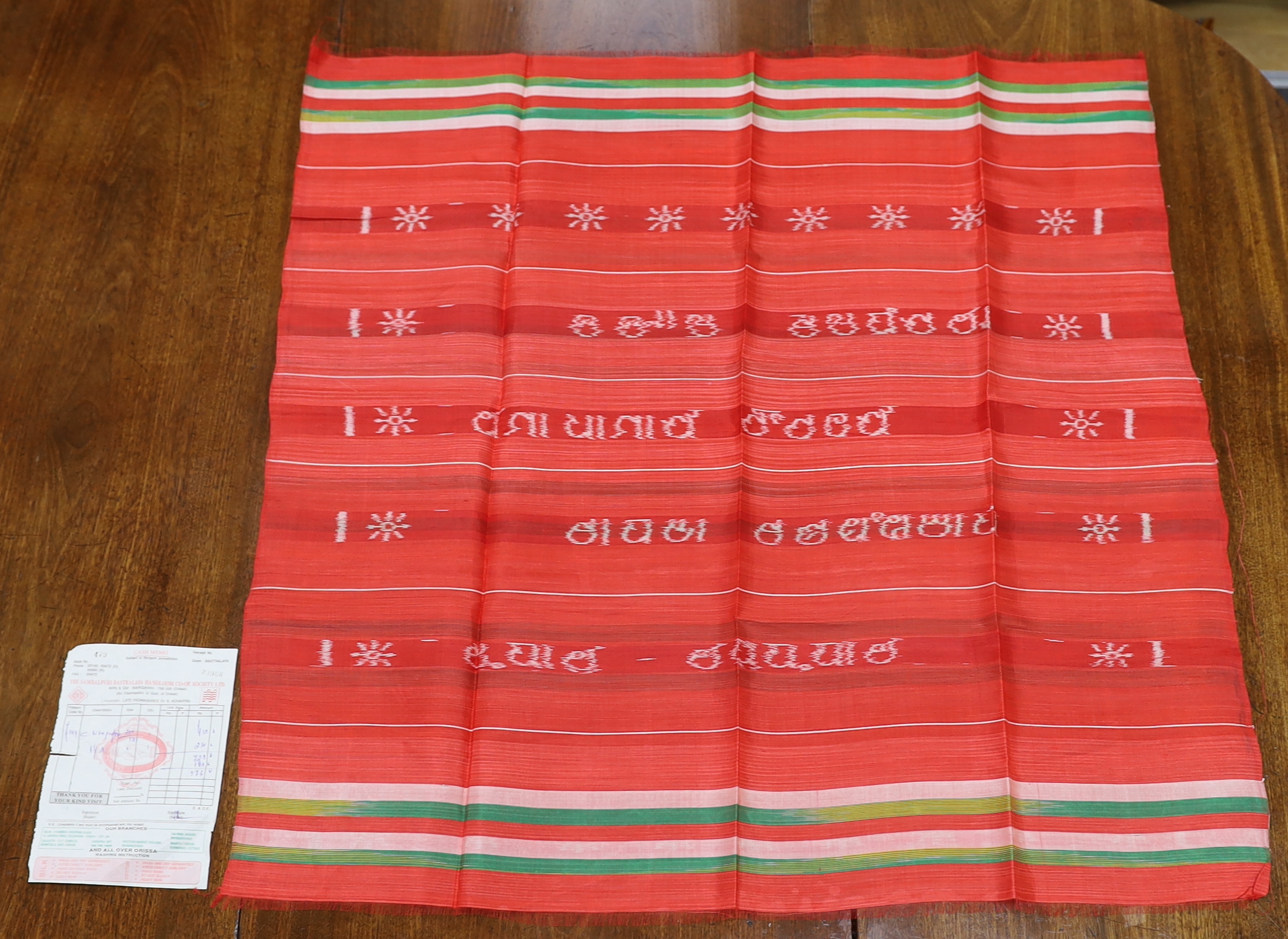 An Indian silk woven cloth, possibly a temple cloth, from Orissa, printed on the warp, with original receipt and paper bag                                                                                                  