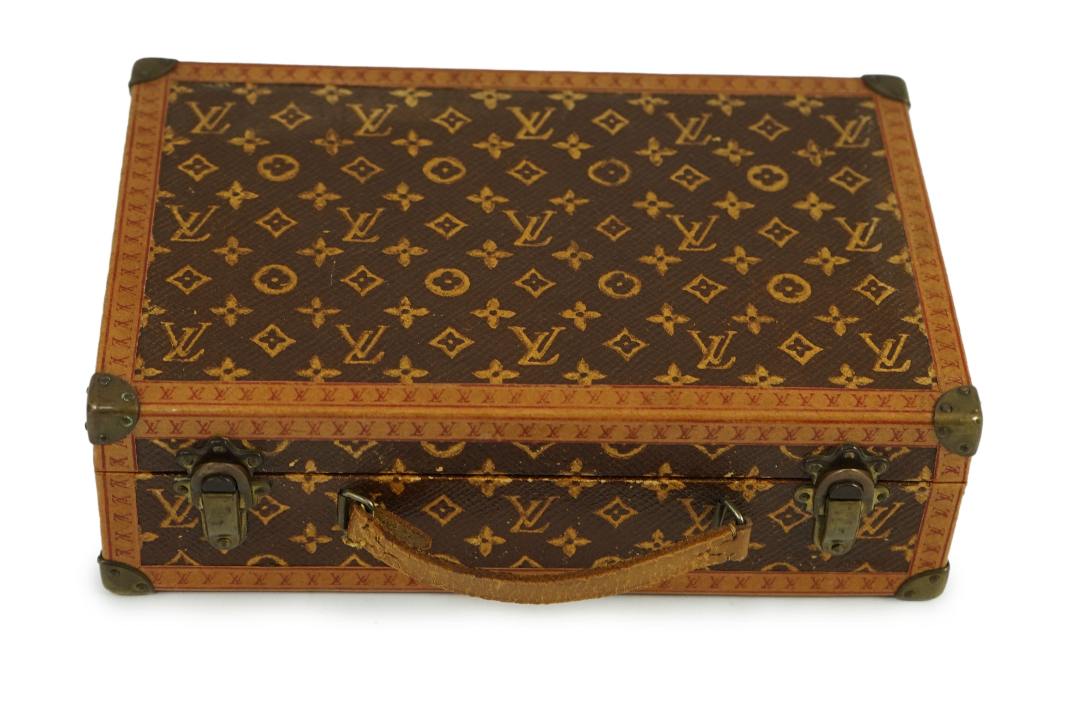 A 1920’s Louis Vuitton miniature suitcase, 20 x 13 x 6cm.                                                                                                                                                                   