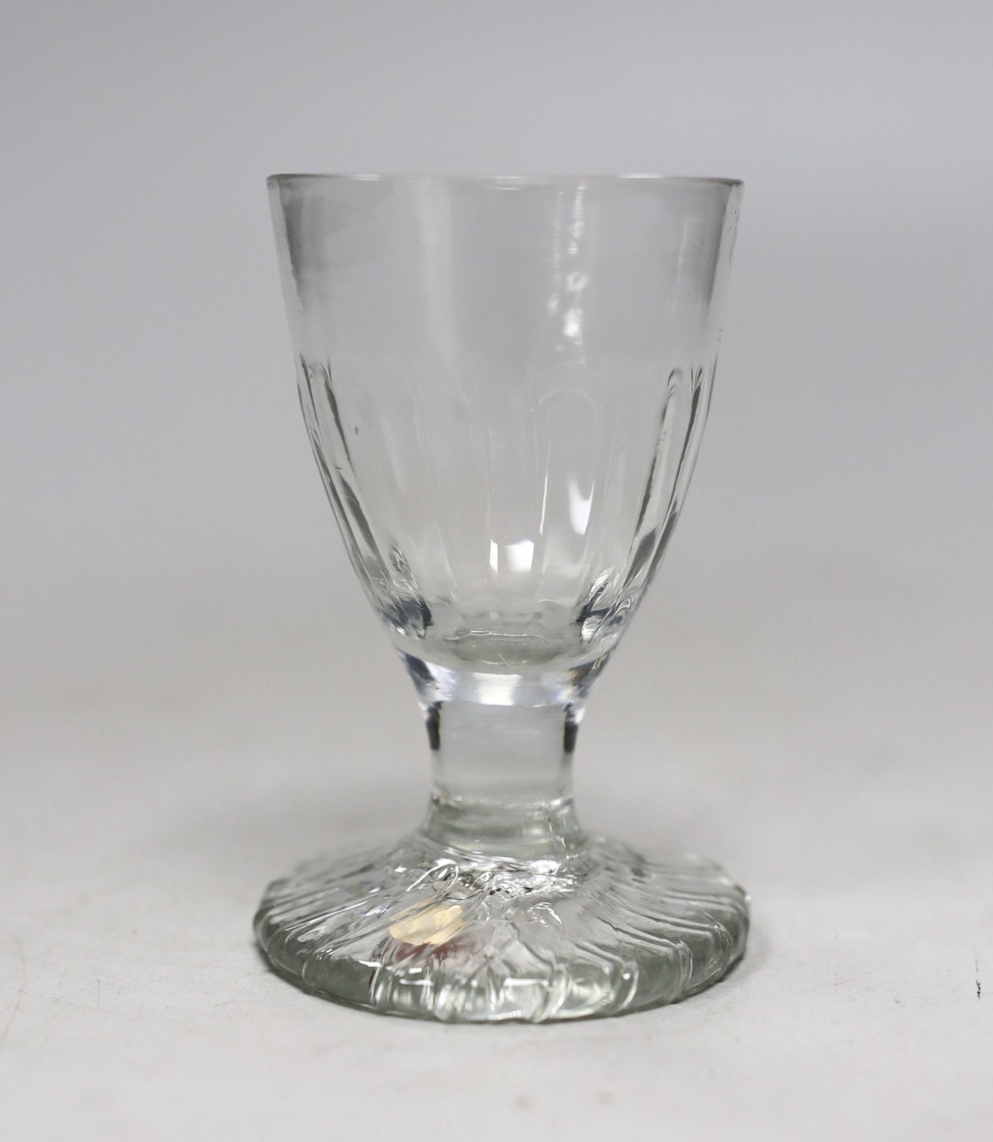A Georgian moulded toasting glass. 9cm tall                                                                                                                                                                                 