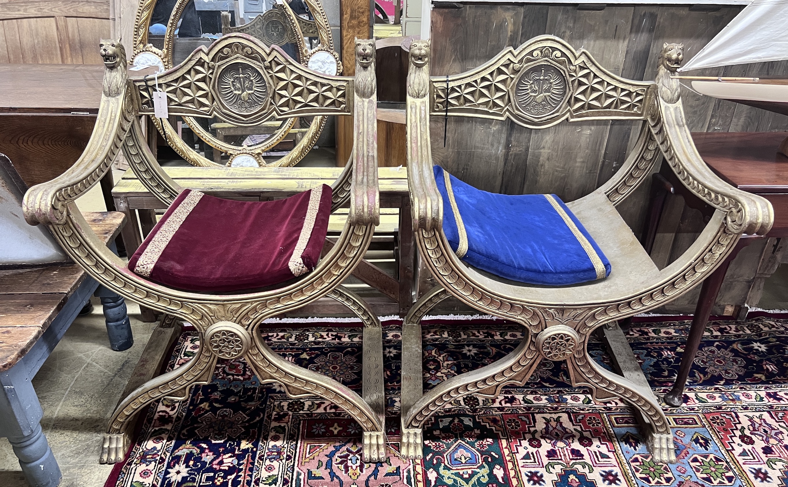 A pair of hardwood and gilt composition 'X' frame chairs, width 72cm, depth 58cm, height 100cm                                                                                                                              