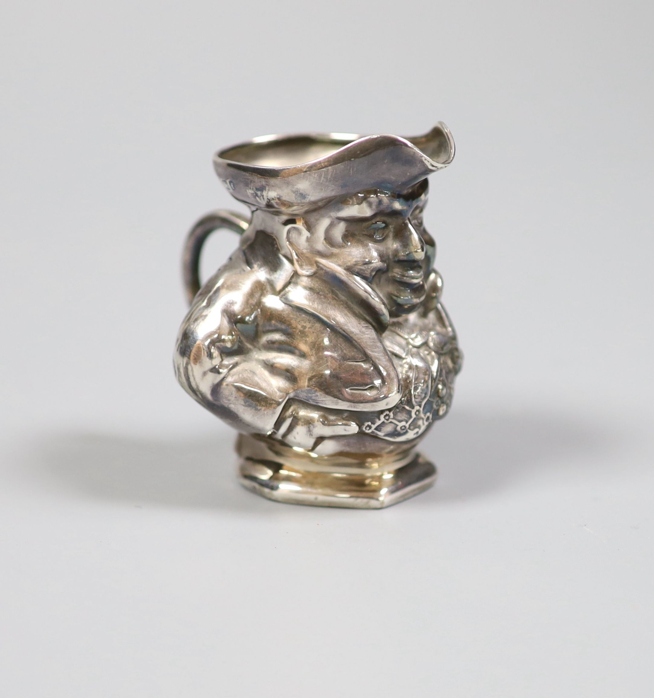 An Edwardian novelty silver cream jug modelled as a Toby jug, maker's mark rubbed, Birmingham, 1905, height 68mm.                                                                                                           