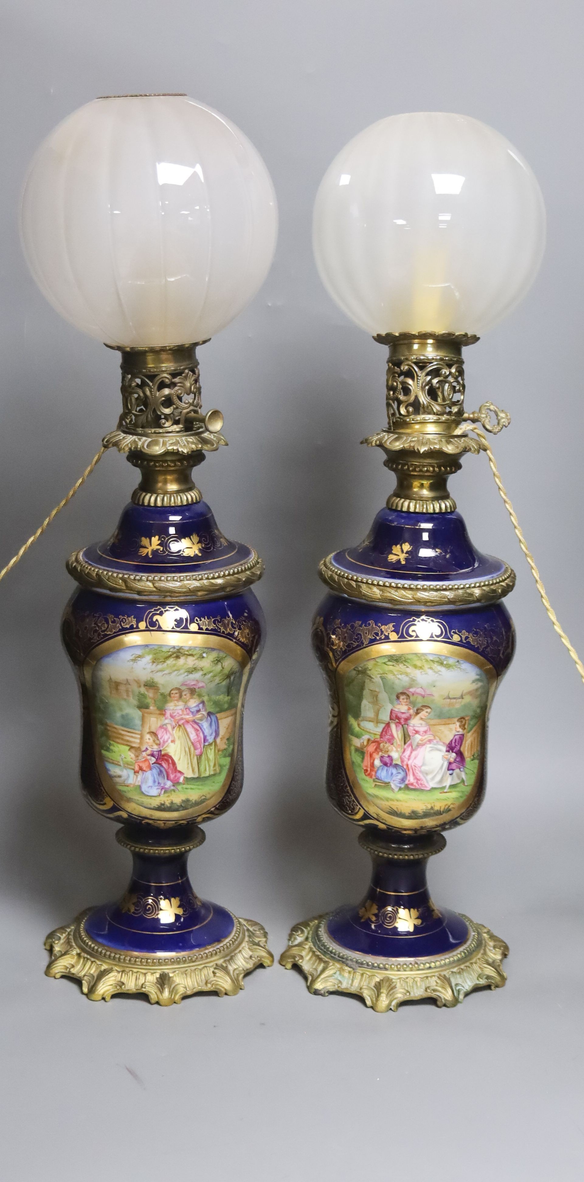 A matched pair of hand-painted Paris porcelain converted oil lamps 57cm                                                                                                                                                     