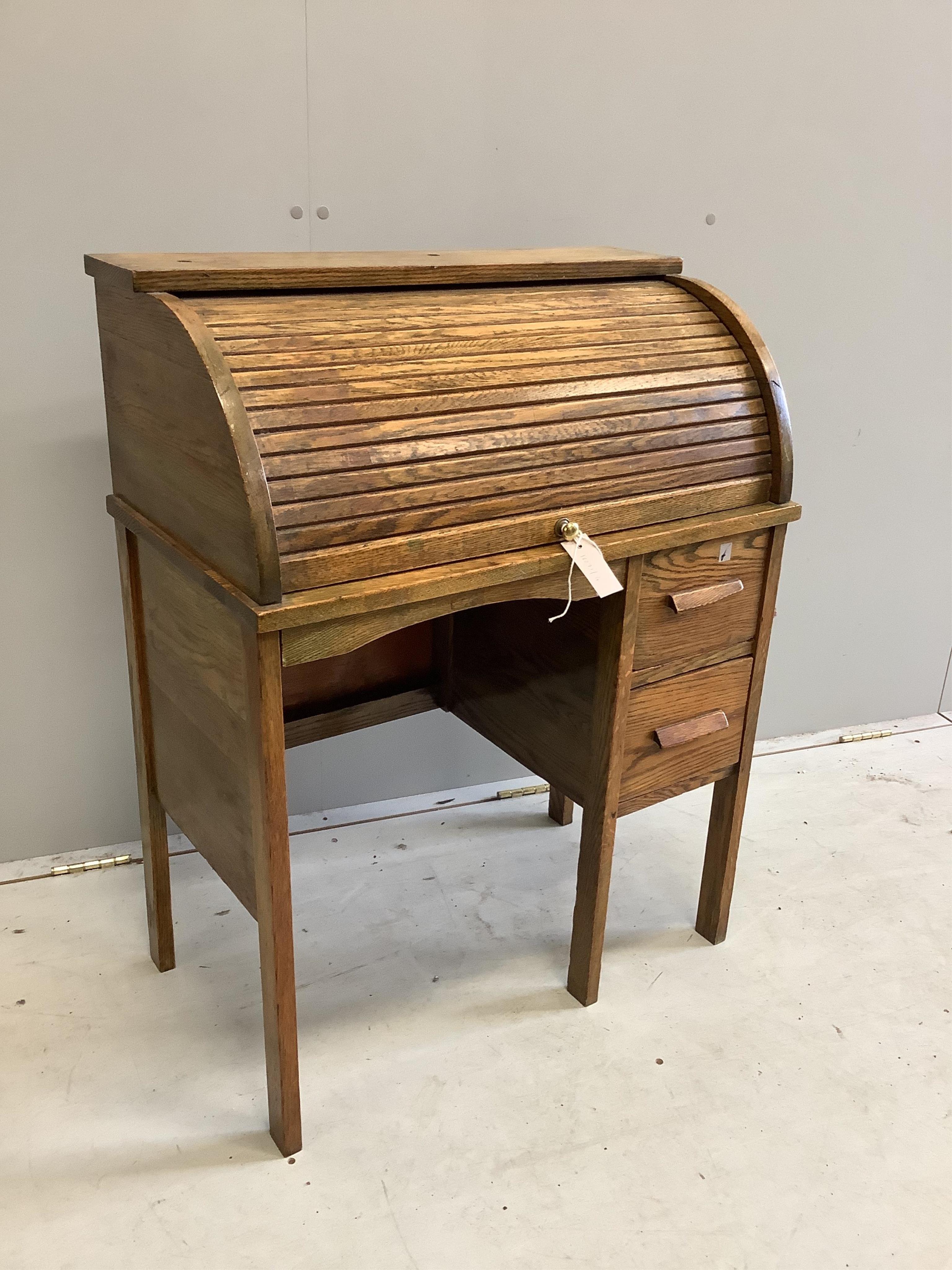 A small early 20th century oak roll top tambour shutter writing desk, width 68cm, depth 38cm, height 87cm. Condition - fair                                                                                                 