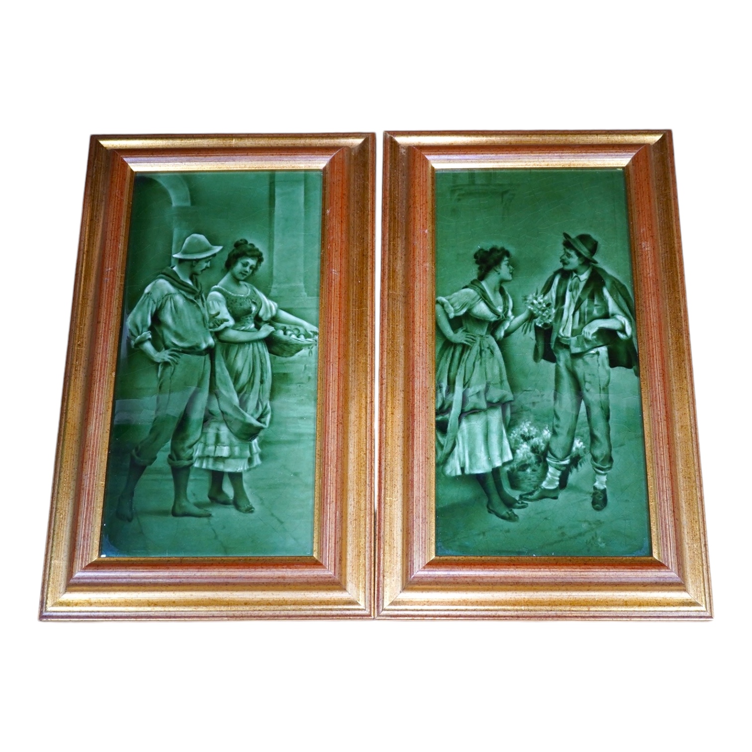 A pair of Craven Dunhill green glazed figurative framed tiles, 29.5cm high, 14cm wide. Condition - good                                                                                                                     