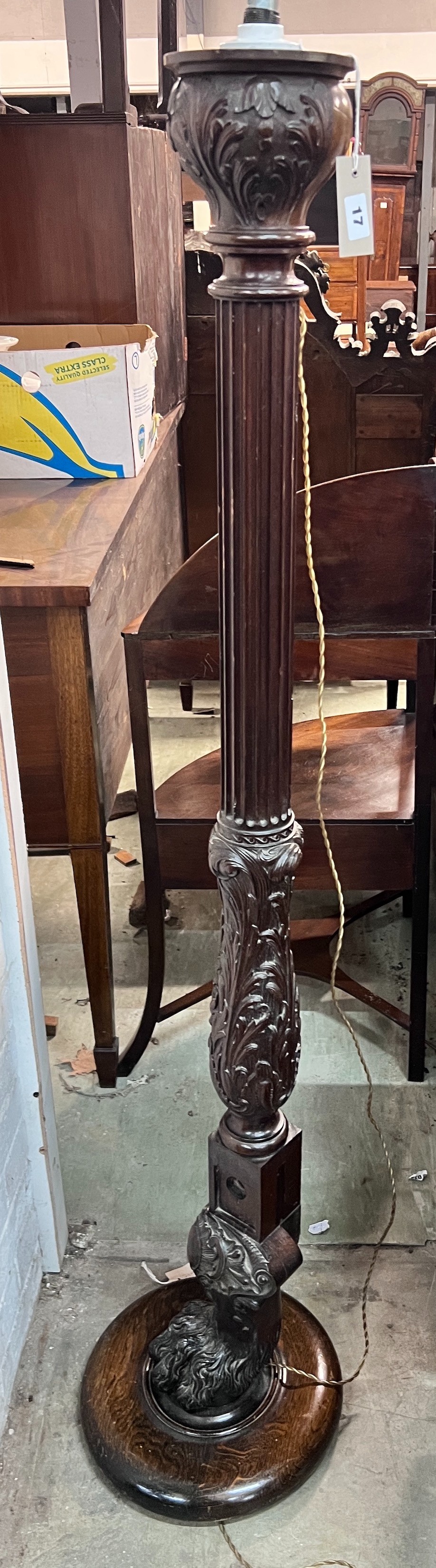 A carved oak and mahogany carved standard lamp, height 151cm *Please note the sale commences at 9am.                                                                                                                        