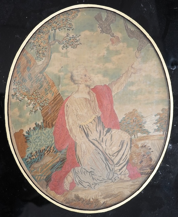 A Regency framed oval silk worked embroidery depicting Elijah being fed by the Ravens, with verre eglomise border, 31cm high. Condition - silk damaged                                                                      