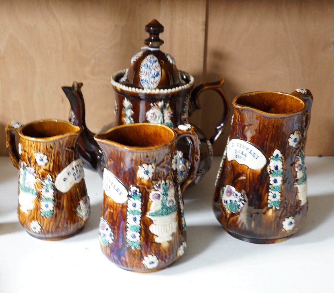 A Victorian Measham pottery bargeware teapot and three graduated jugs (4)                                                                                                                                                   