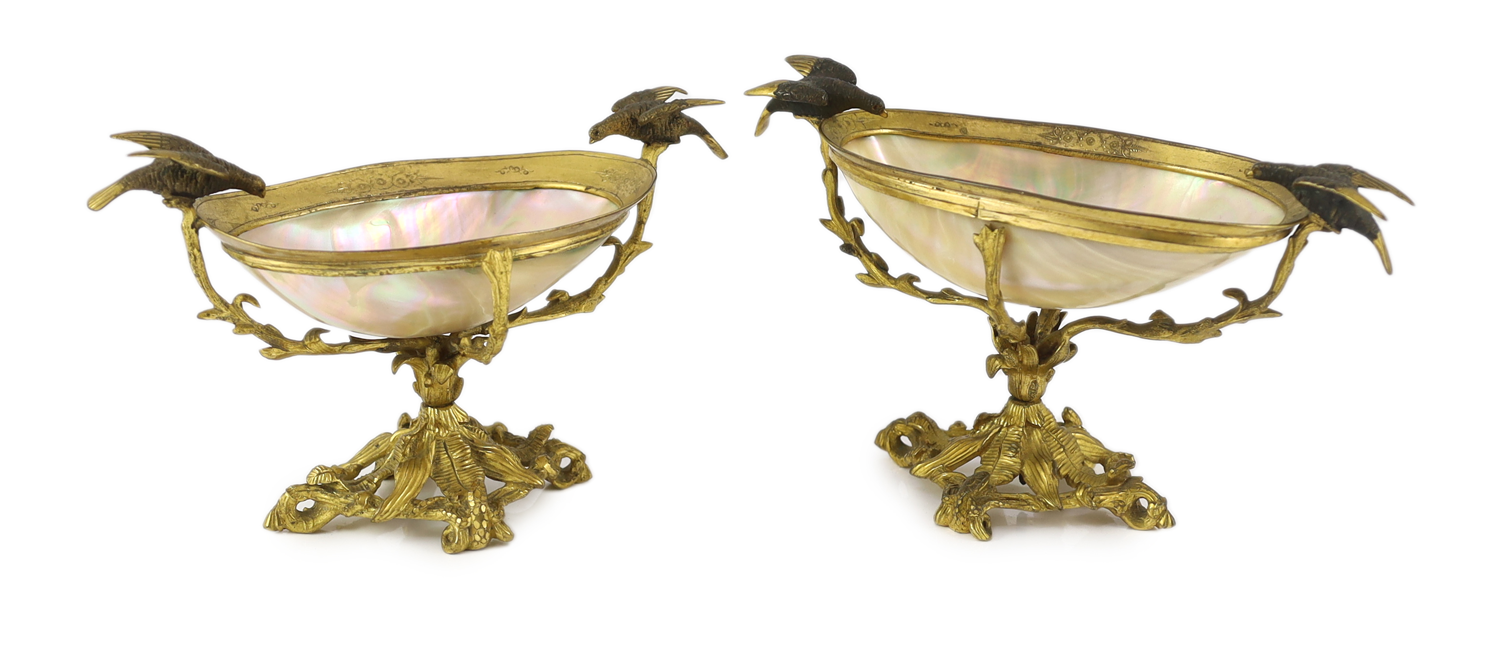 A graduated pair of 19th century Continental ormolu mounted mother of pearl pedestal bowls                                                                                                                                  