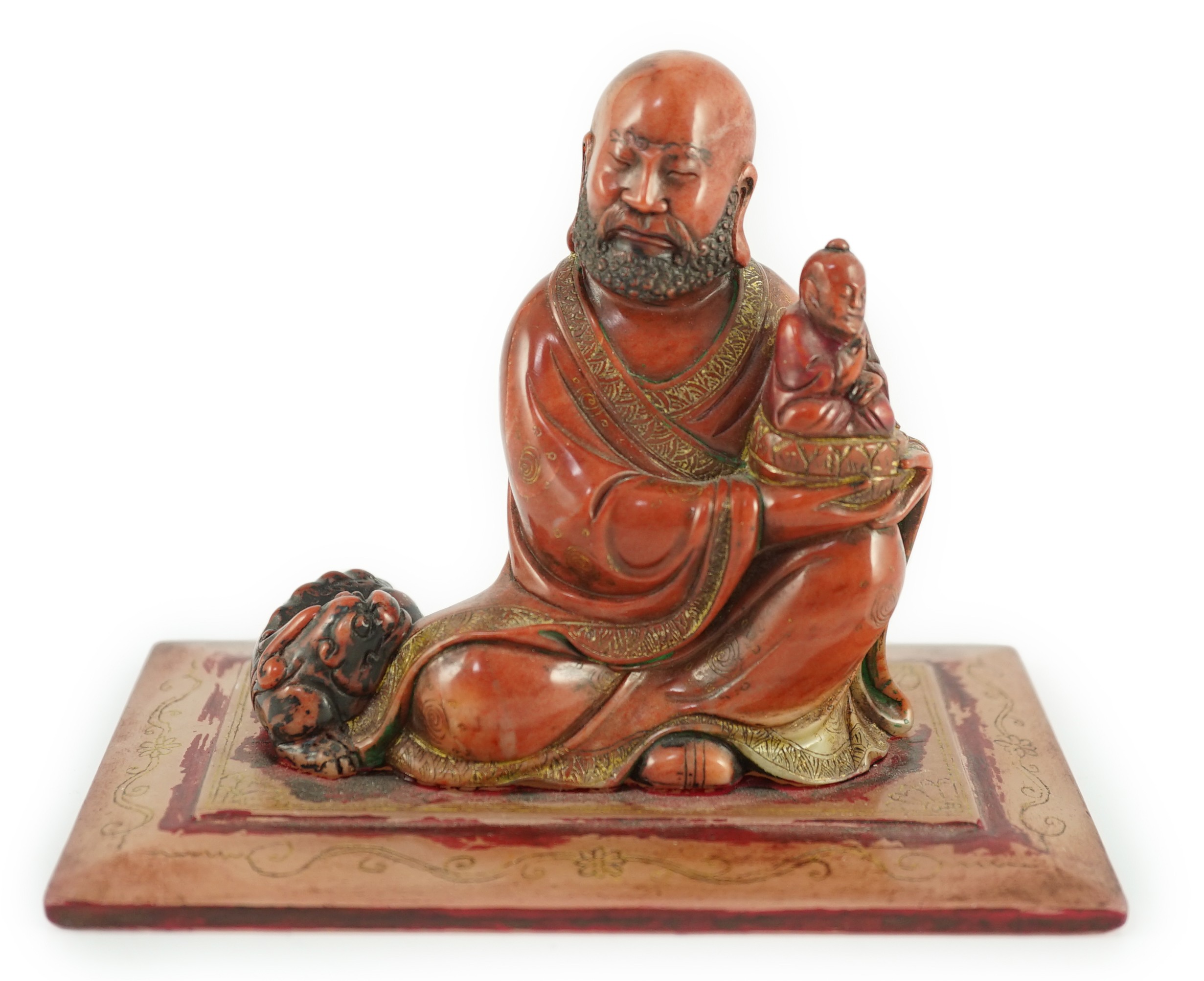 A Chinese soapstone group of a luohan holding a figure of Buddha, 18th century, 12cm wide, 9cm high                                                                                                                         