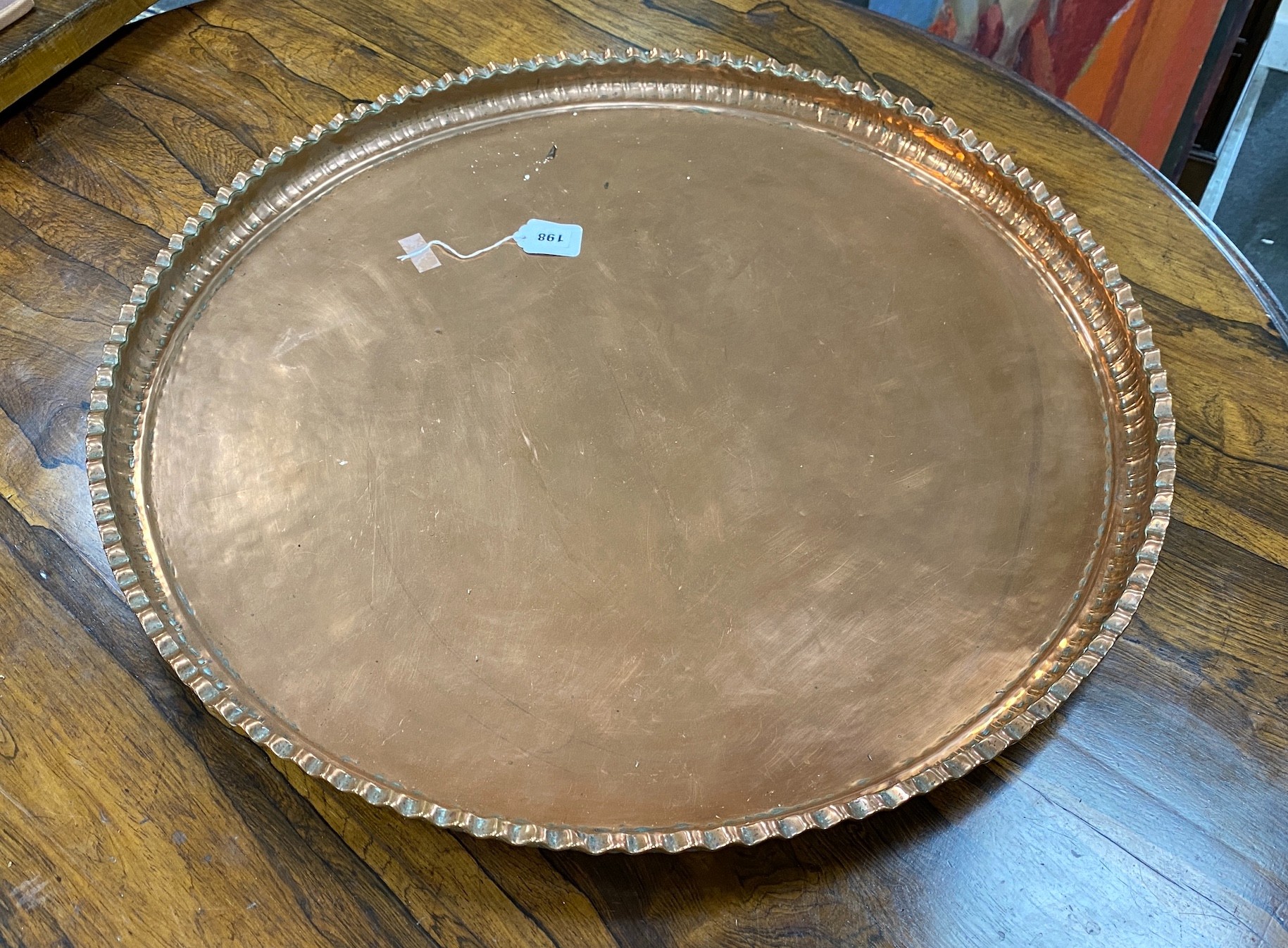 A large circular copper tray, diameter 74cm                                                                                                                                                                                 