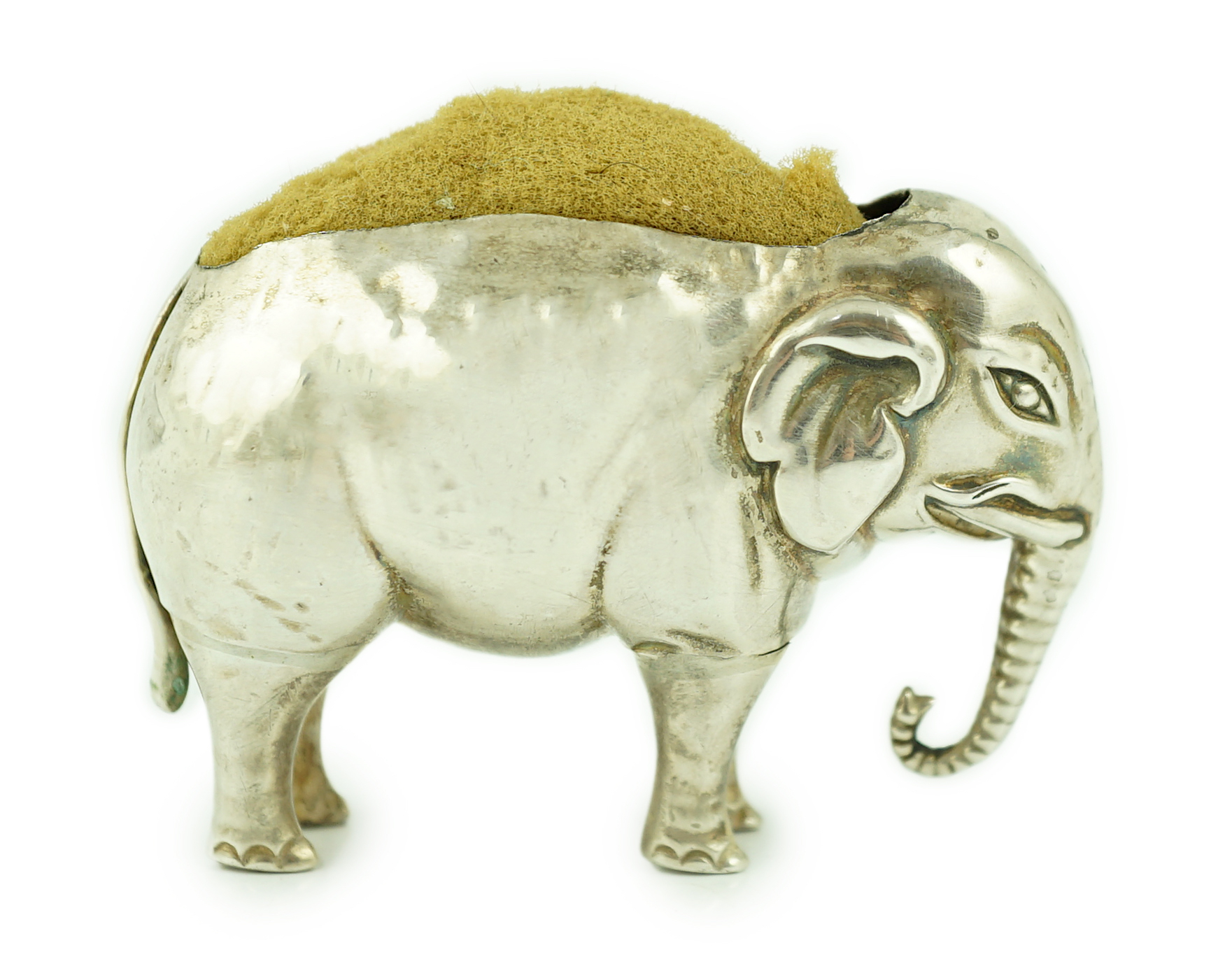 A George V novelty silver pin cushion, modelled as an elephant, Adie & Lovekin Ltd                                                                                                                                          